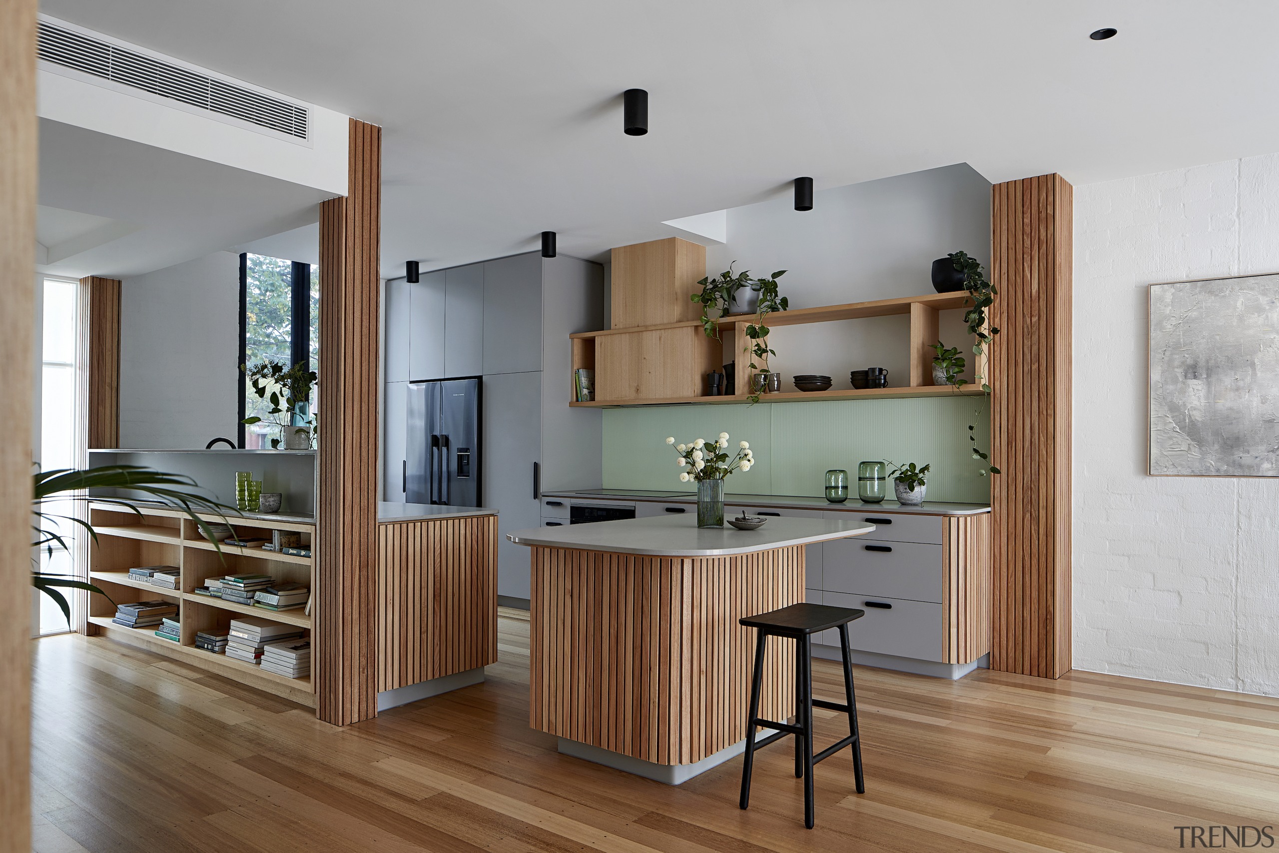 The kitchen is split into distinct bench zones, 