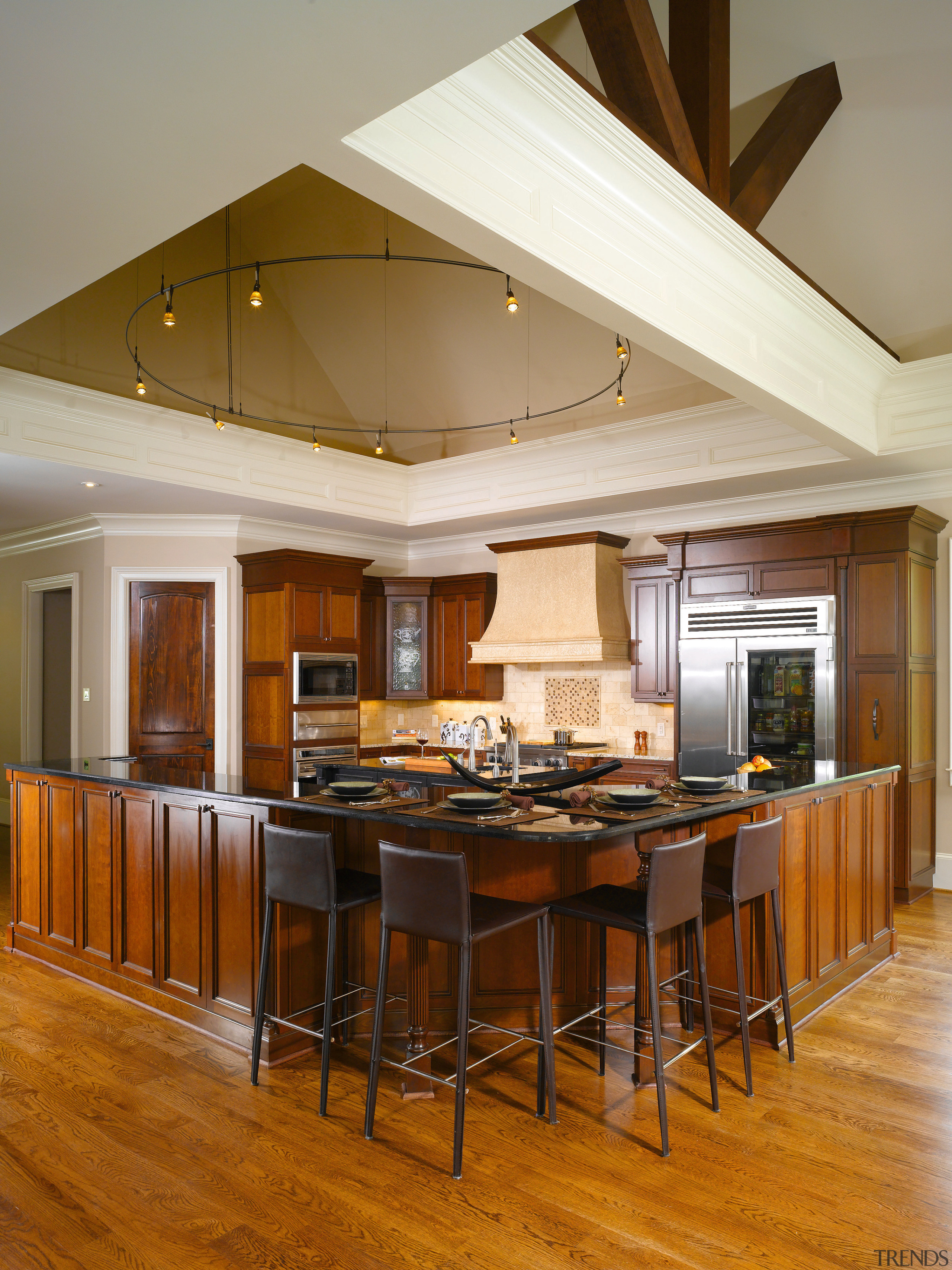 The design of this kitchen follows the broad, ceiling, countertop, dining room, floor, flooring, hardwood, interior design, kitchen, living room, real estate, room, table, wood flooring, brown, gray