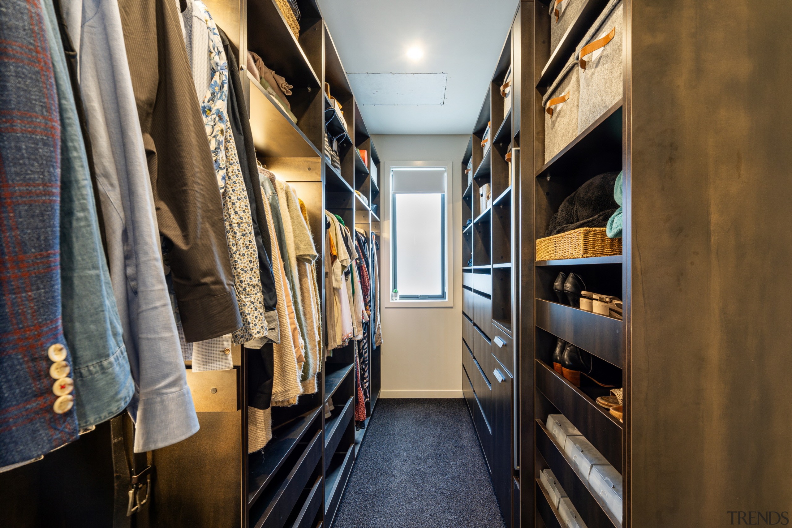 The generous walk-in wardrobe is finished with wood 