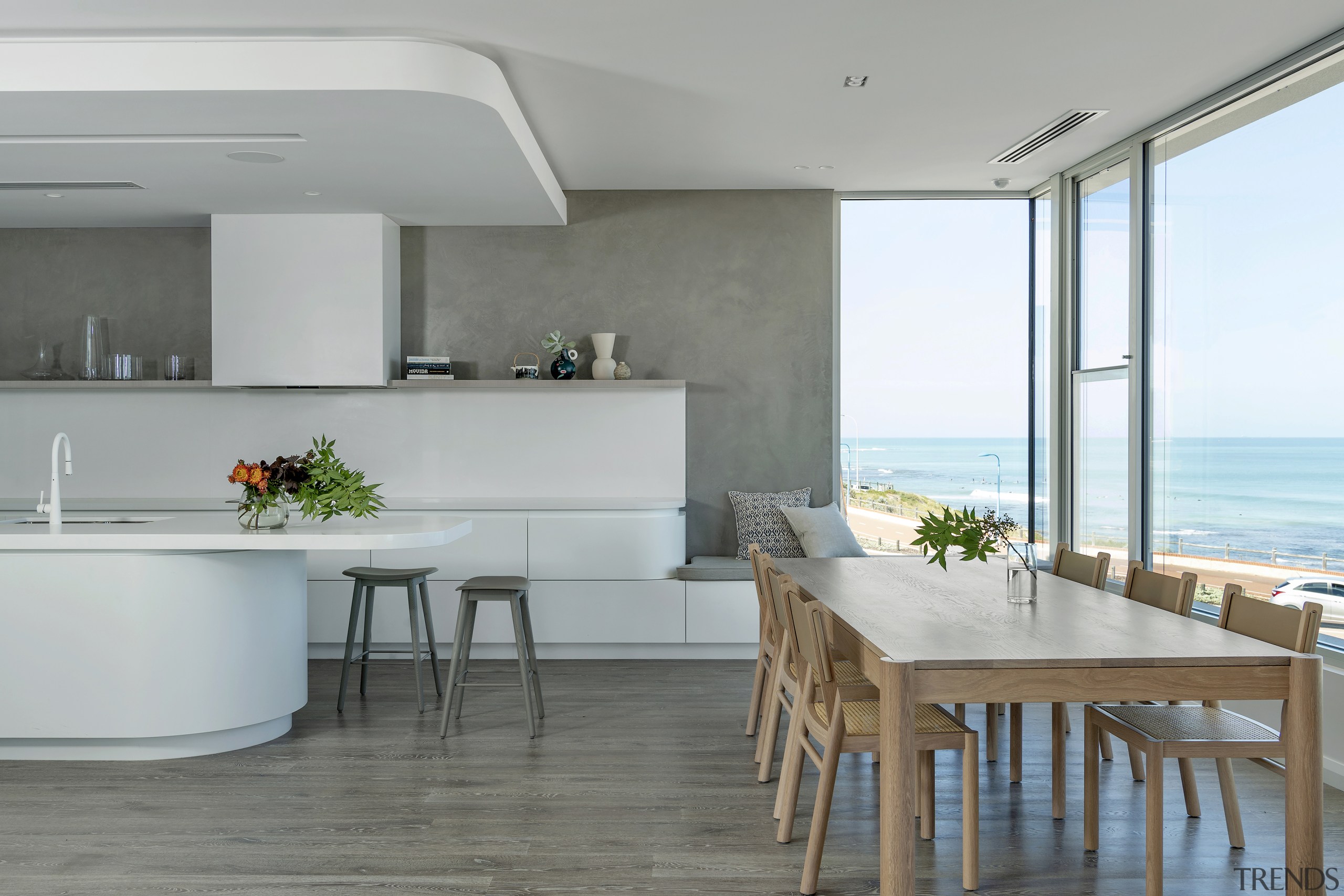 A generous-sized wooden dining table and chairs connect 