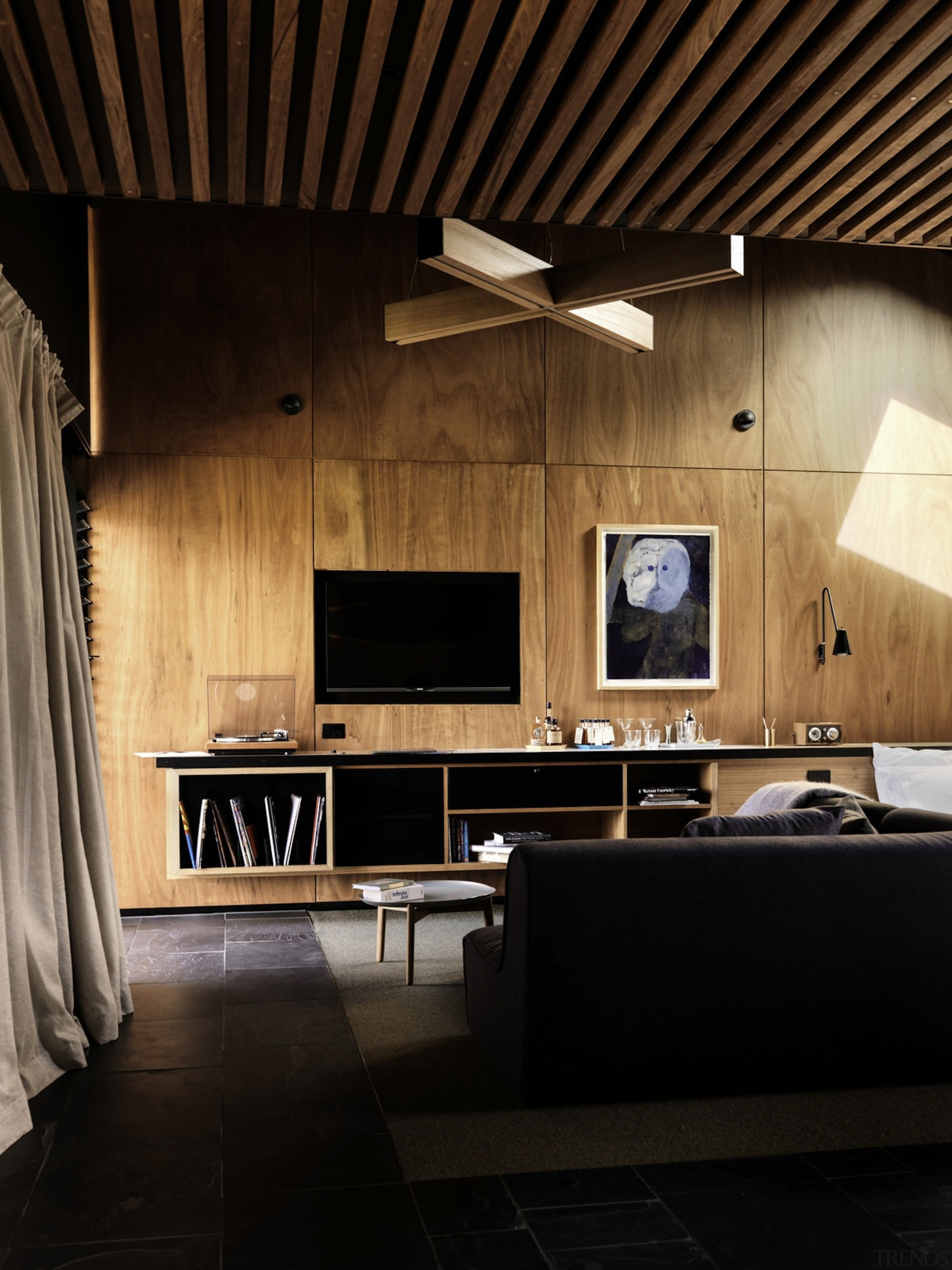 Wood panel walls are in keeping with the architecture, ceiling, floor, flooring, furniture, interior design, living room, table, wall, wood, black