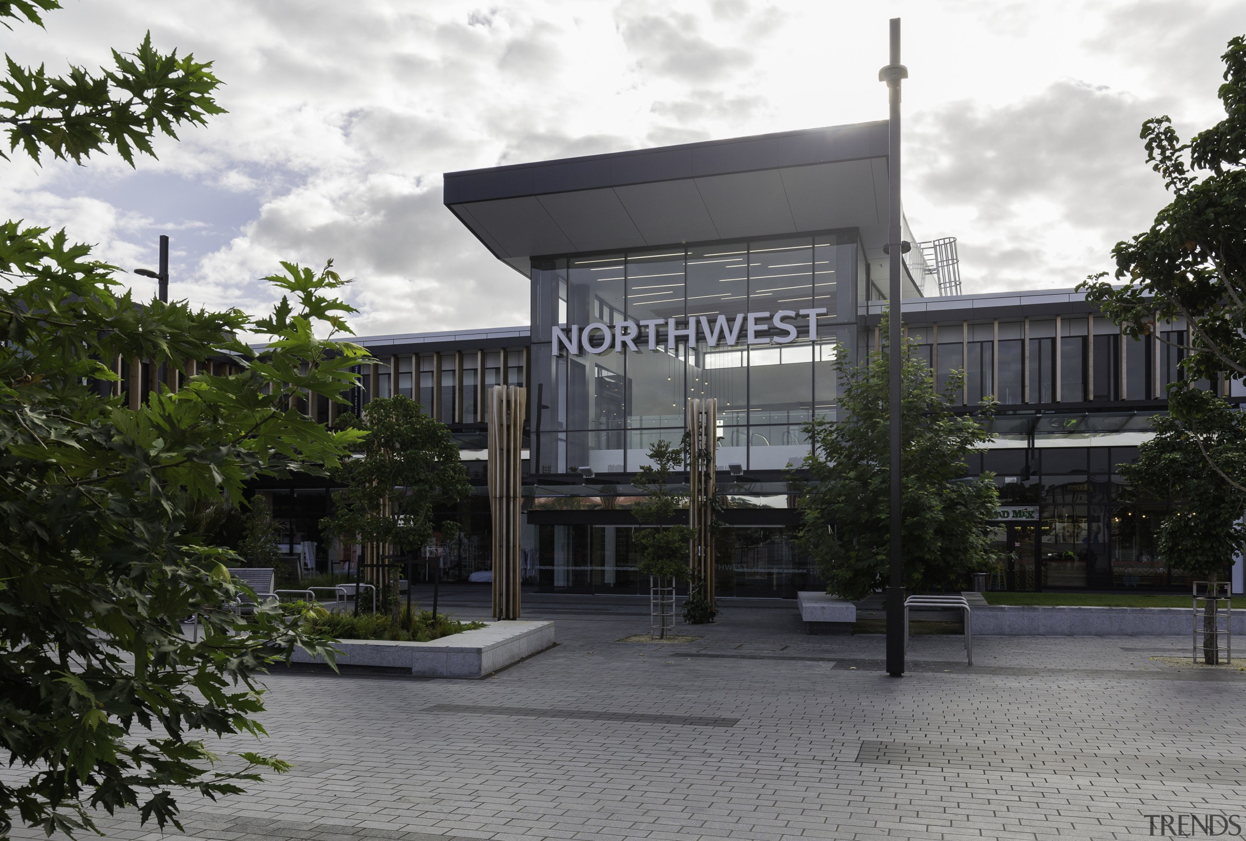 A double-height, glass fronted atrium provides the high-profile architecture, building, commercial building, condominium, corporate headquarters, facade, mixed use, real estate, tree, gray