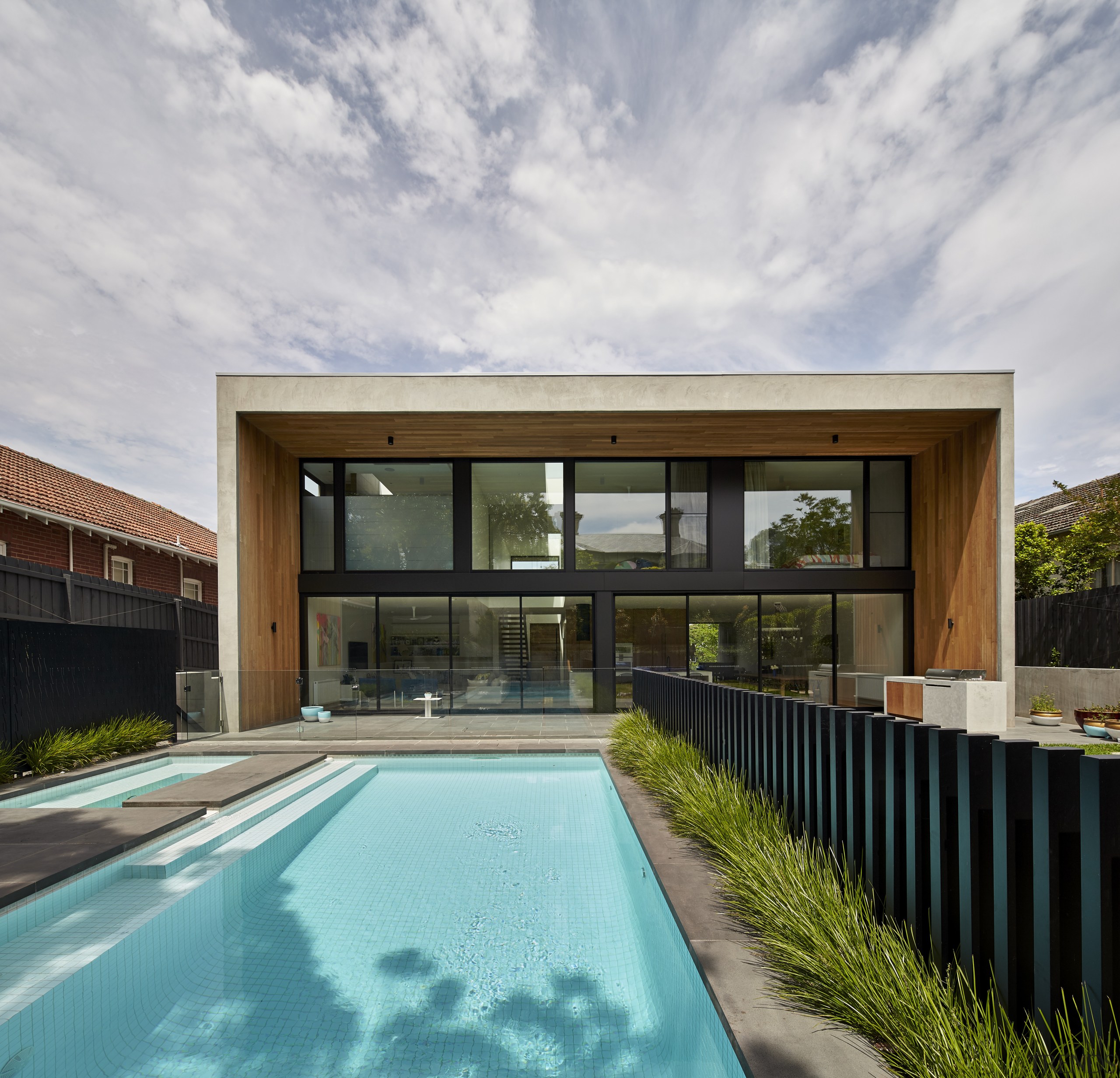 The entire rear facade of this contemporary home architecture, estate, facade, home, house, property, real estate, reflection, roof, sky, swimming pool, villa, gray