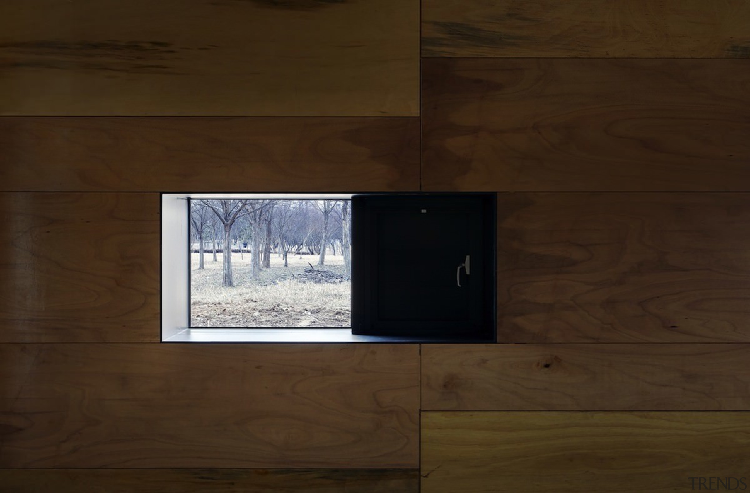 This window provides a view of the forest architecture, floor, wall, wood, wood flooring, wood stain, brown