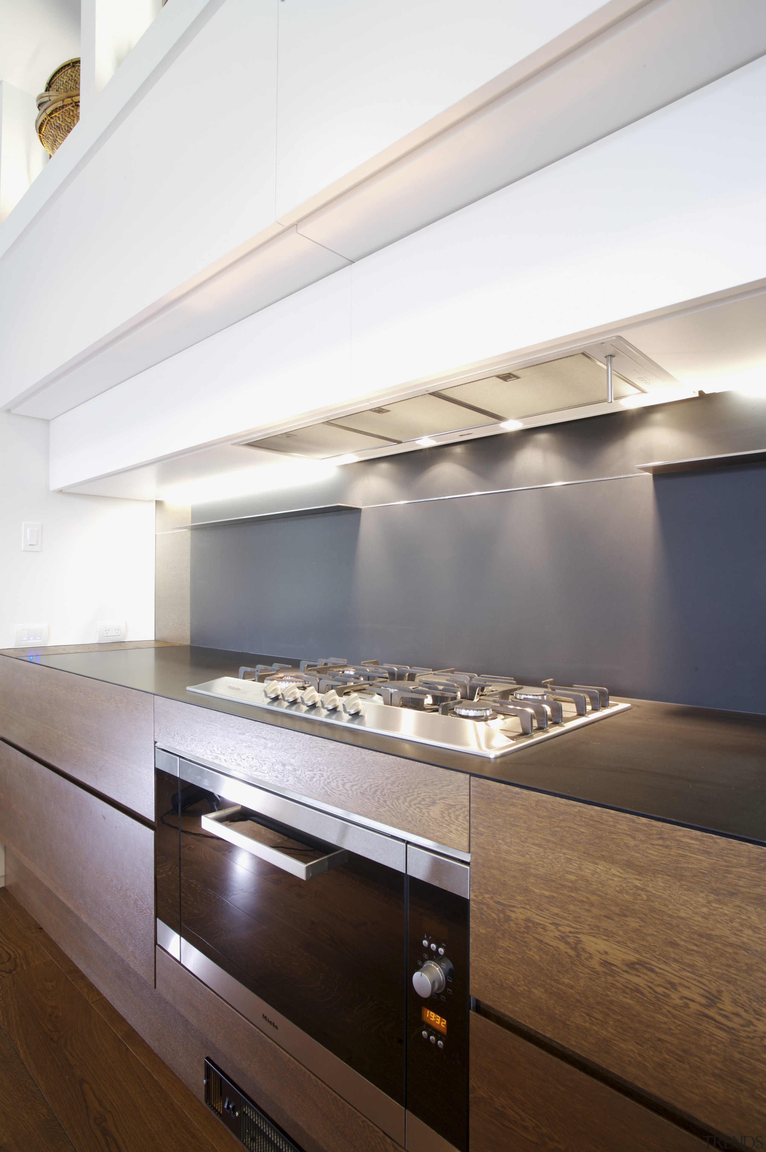 View of contemporary kitchen with wooden island and architecture, ceiling, countertop, daylighting, interior design, kitchen, under cabinet lighting, white, brown