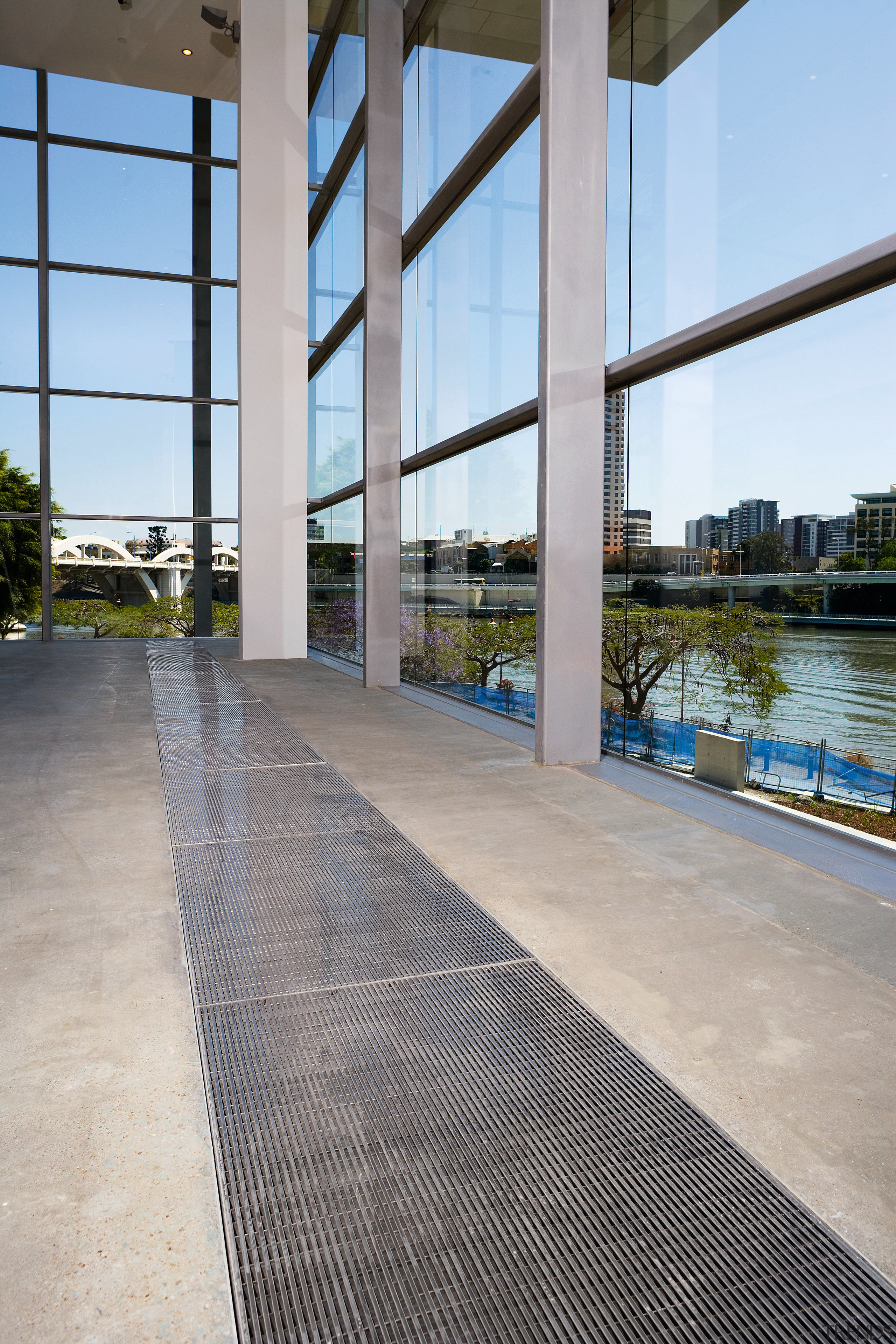 A viewof some polished concrete flooring by ACO apartment, architecture, building, condominium, floor, flooring, real estate, reflection, sky, walkway, water, window, gray