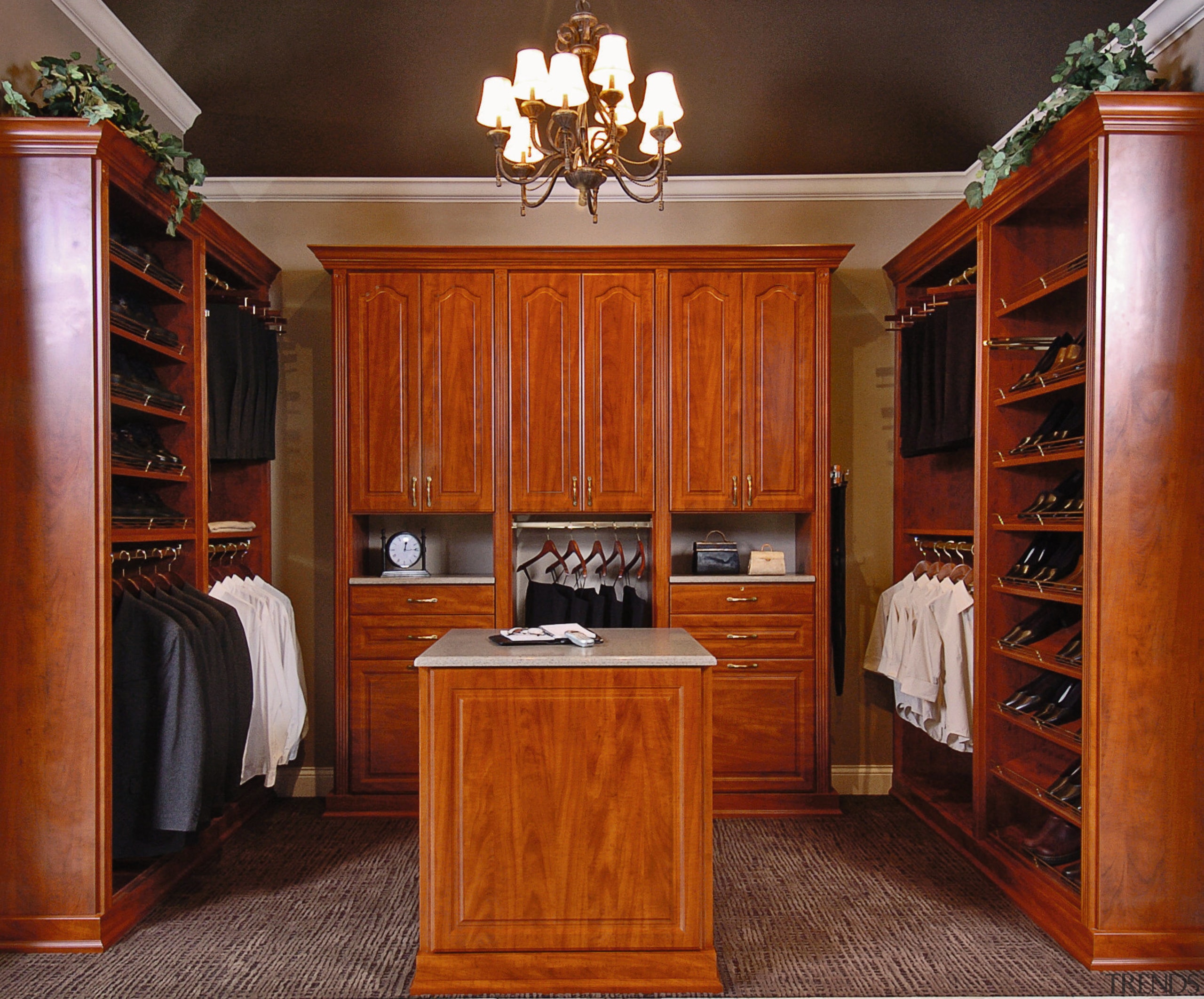 View of bedroom closet storage room with timber bookcase, cabinetry, closet, flooring, furniture, hardwood, interior design, room, shelving, wood, wood stain, brown, red