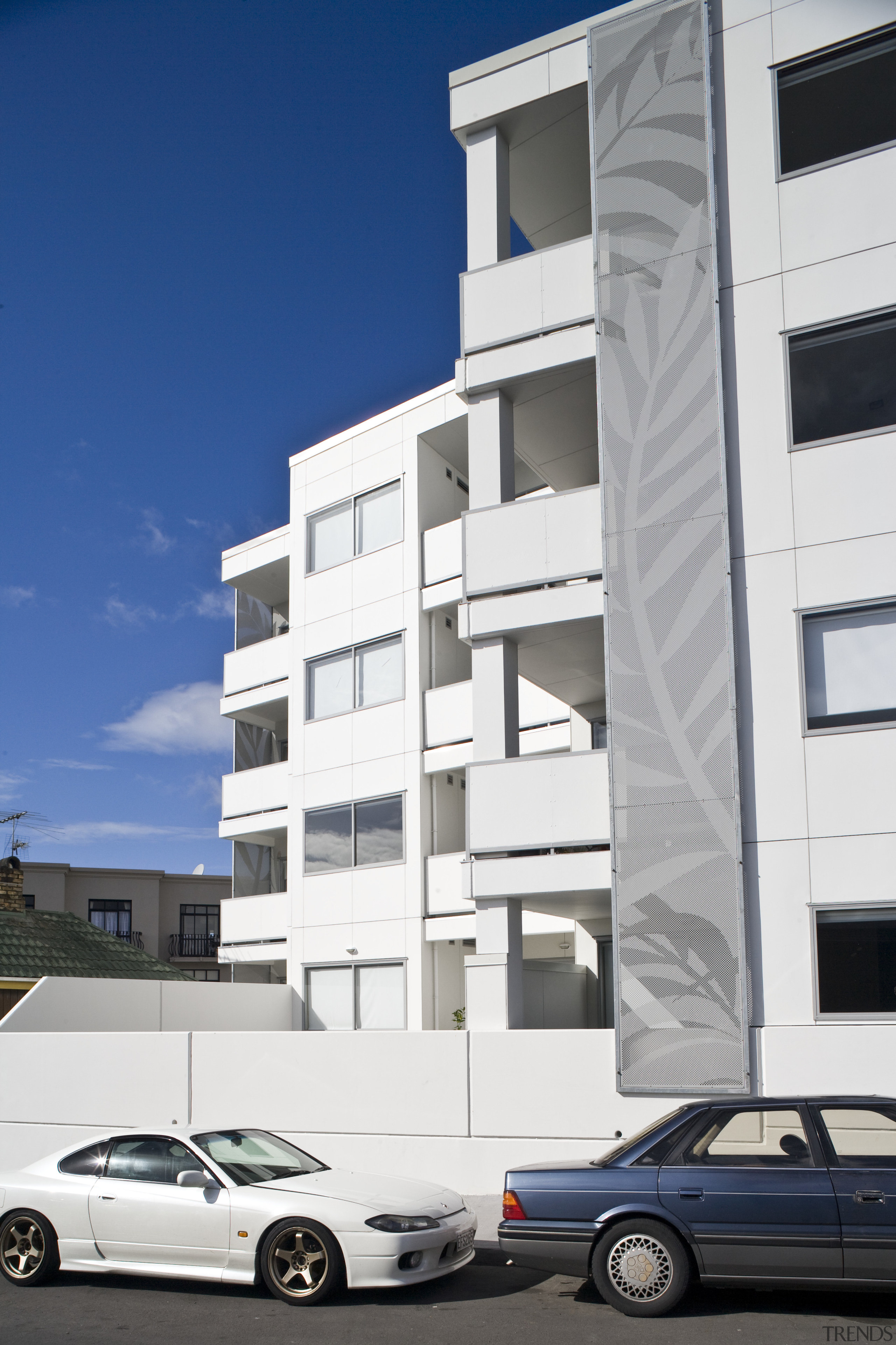 Exterior view of the Ivory apartments which features apartment, architecture, building, commercial building, condominium, corporate headquarters, daytime, elevation, facade, family car, house, metropolitan area, mid size car, mixed use, neighbourhood, property, real estate, residential area, sky, white, blue, gray
