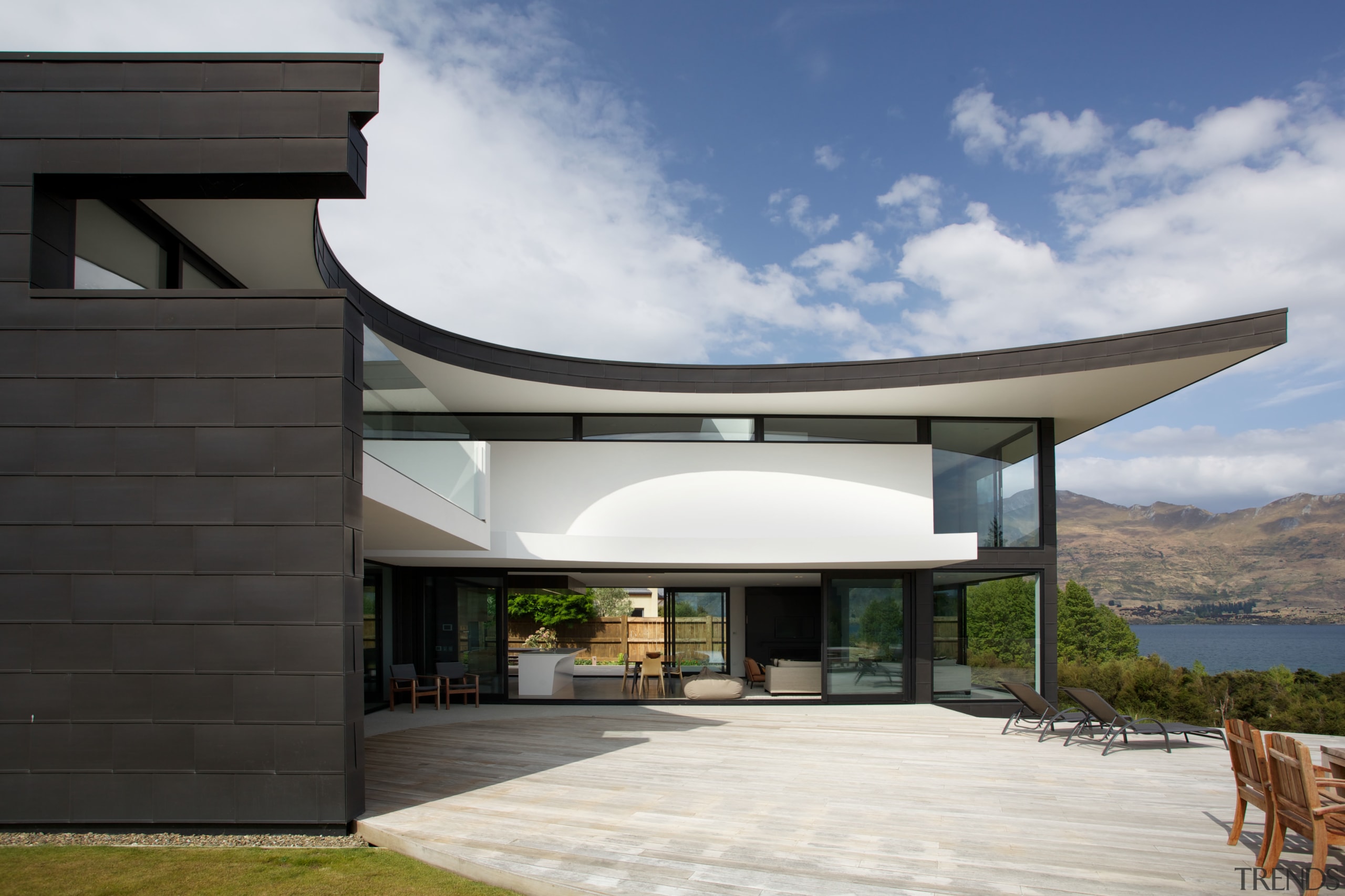 The elliptical decks, overhangs and roof forms of architecture, facade, home, house, property, real estate, black, gray