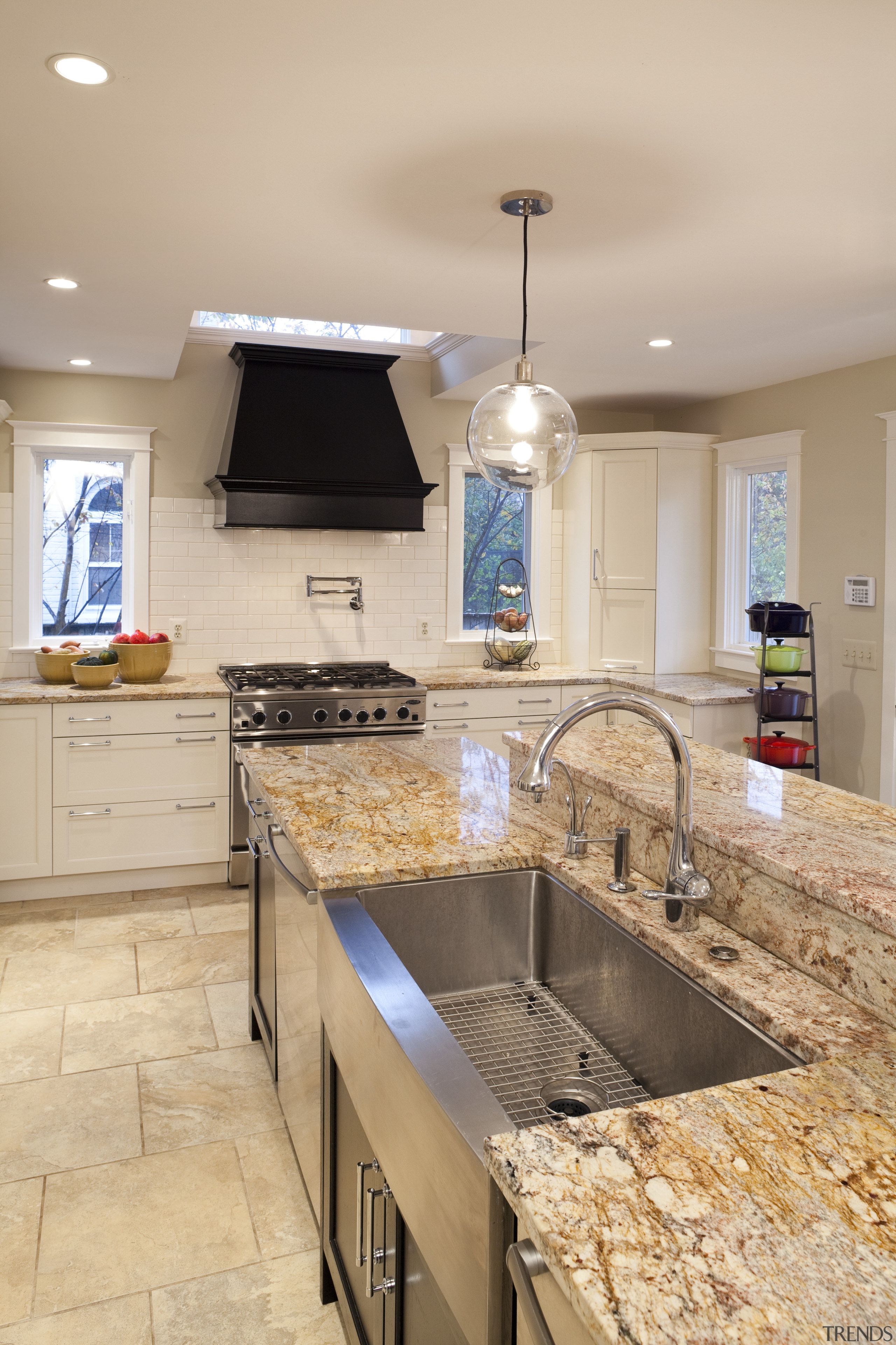 This kitchen was designed by Nadia Subaran of cabinetry, countertop, floor, flooring, home, interior design, kitchen, room, tile, wood flooring, orange