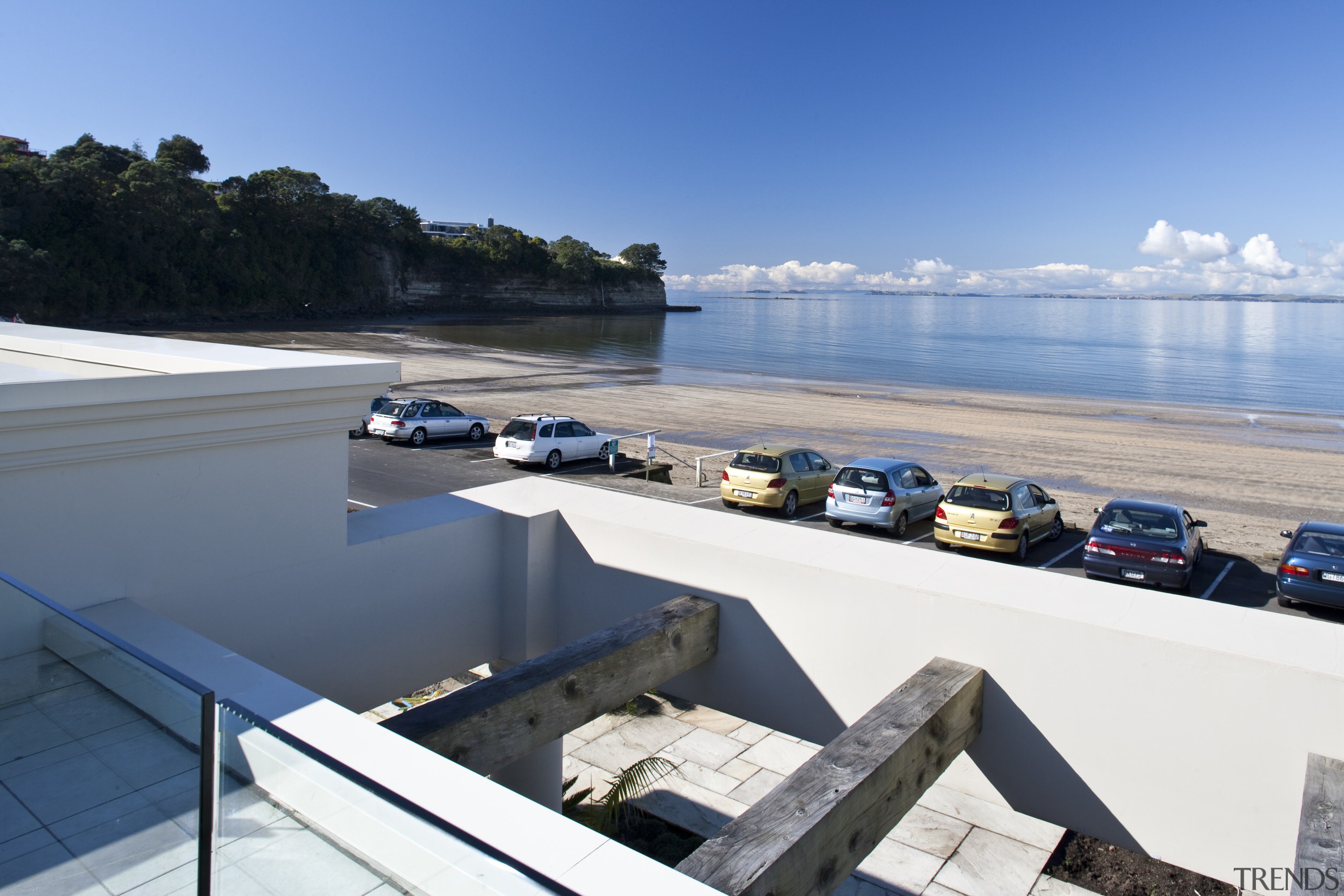 View of the exterior of this modern home sea, sky, water, white, teal