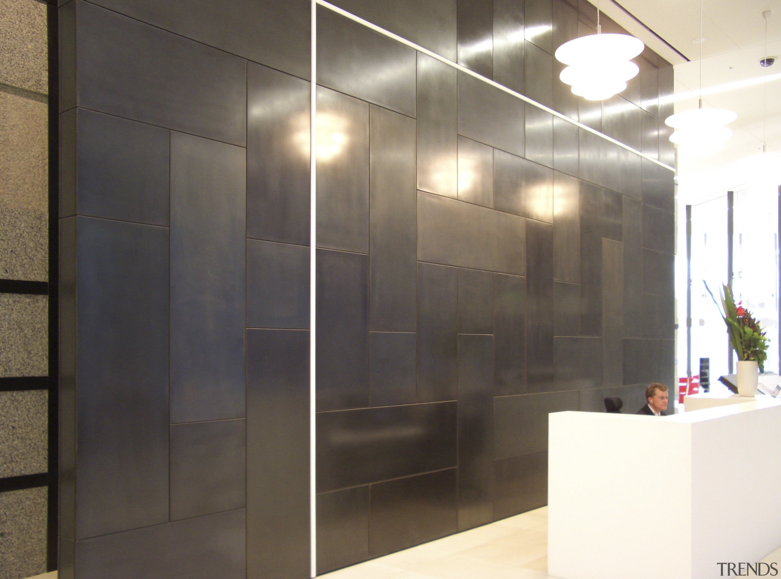 View of brass walls fabricated by Craft Metals door, flooring, glass, interior design, lobby, wall, black, white