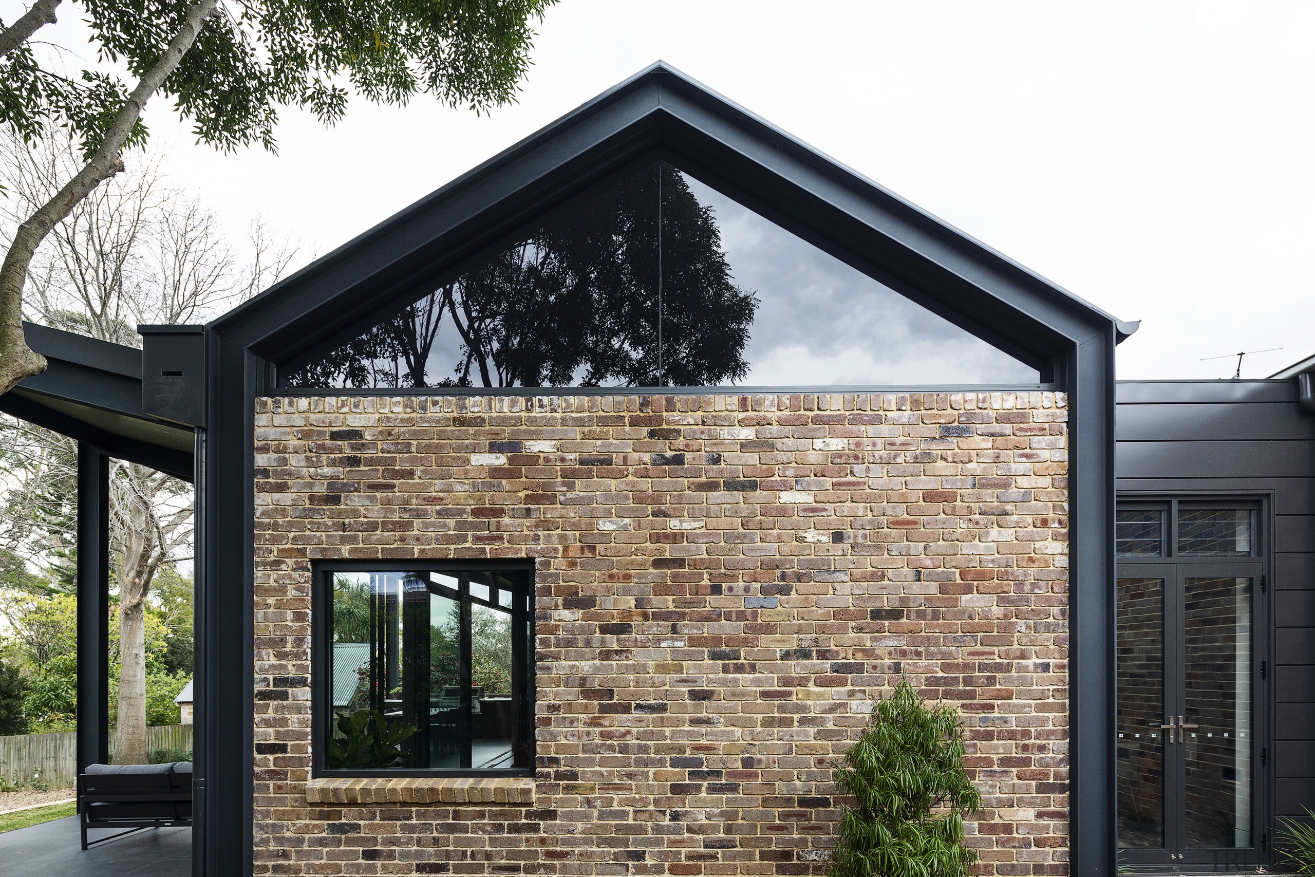 The glass windows under the new gabled roof 