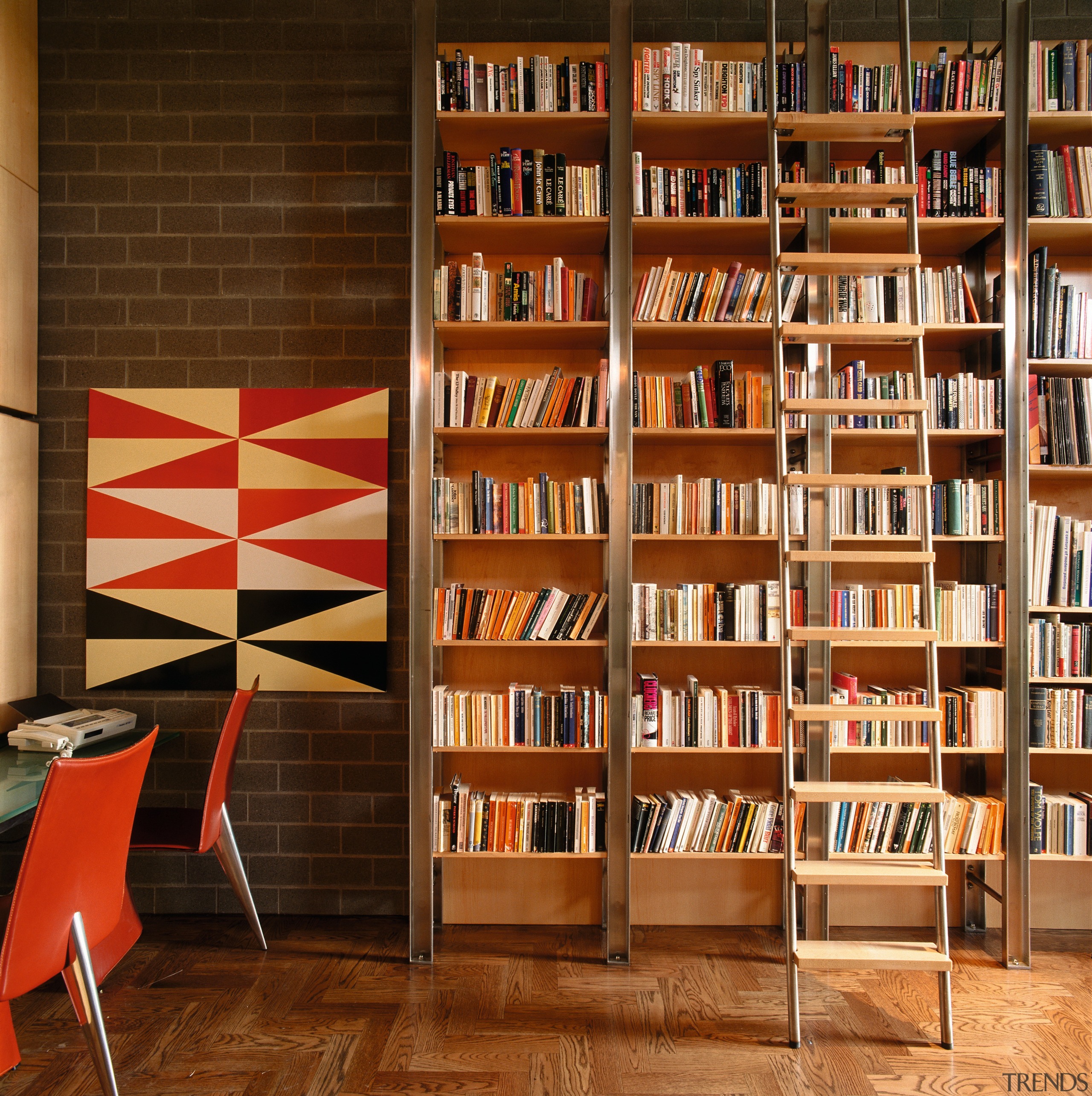 An interior view of the living areas featuring bookcase, bookselling, furniture, institution, interior design, library, library science, public library, shelf, shelving, wood, brown