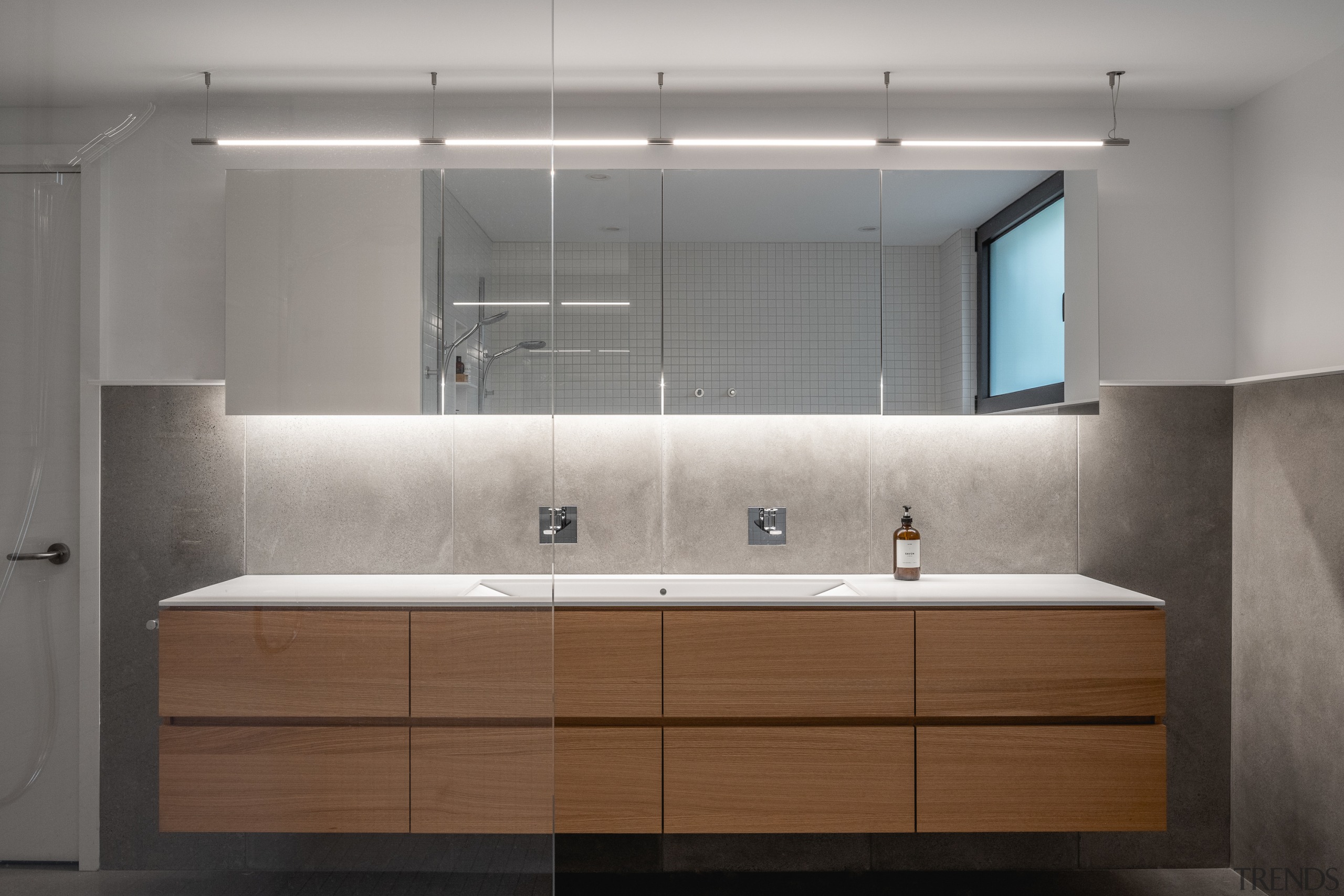 In the basement bathroom, polished concrete wall panels 