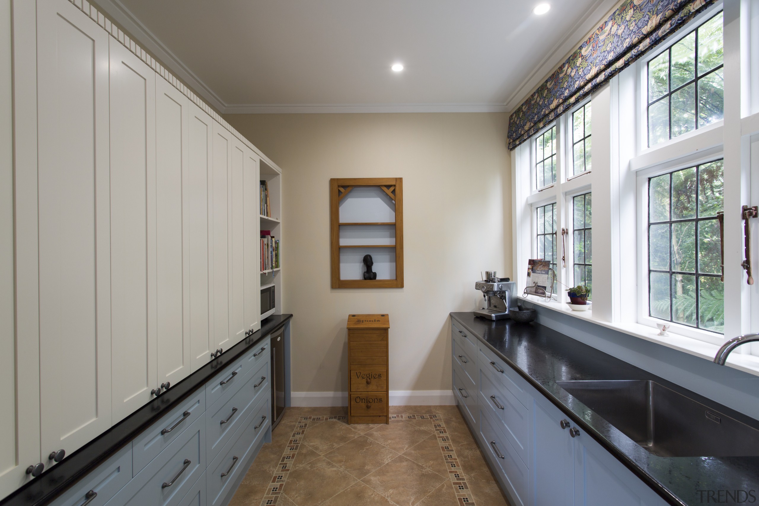 This kitchen was designed largely around the needs floor, home, house, property, real estate, room, window, wood, gray