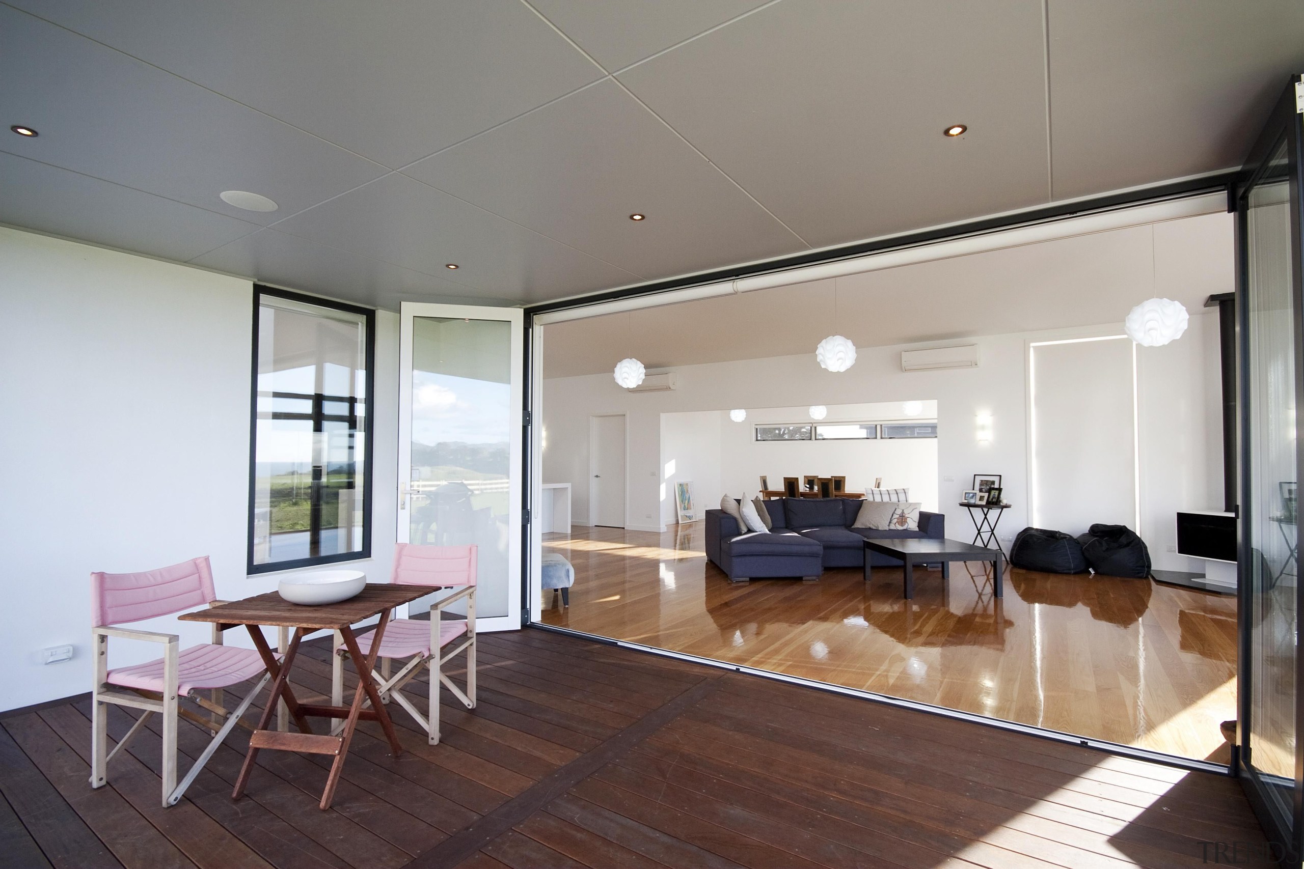 Great indoor /outdoor flow in this home built apartment, ceiling, floor, flooring, house, interior design, living room, property, real estate, room, window, wood, wood flooring, gray