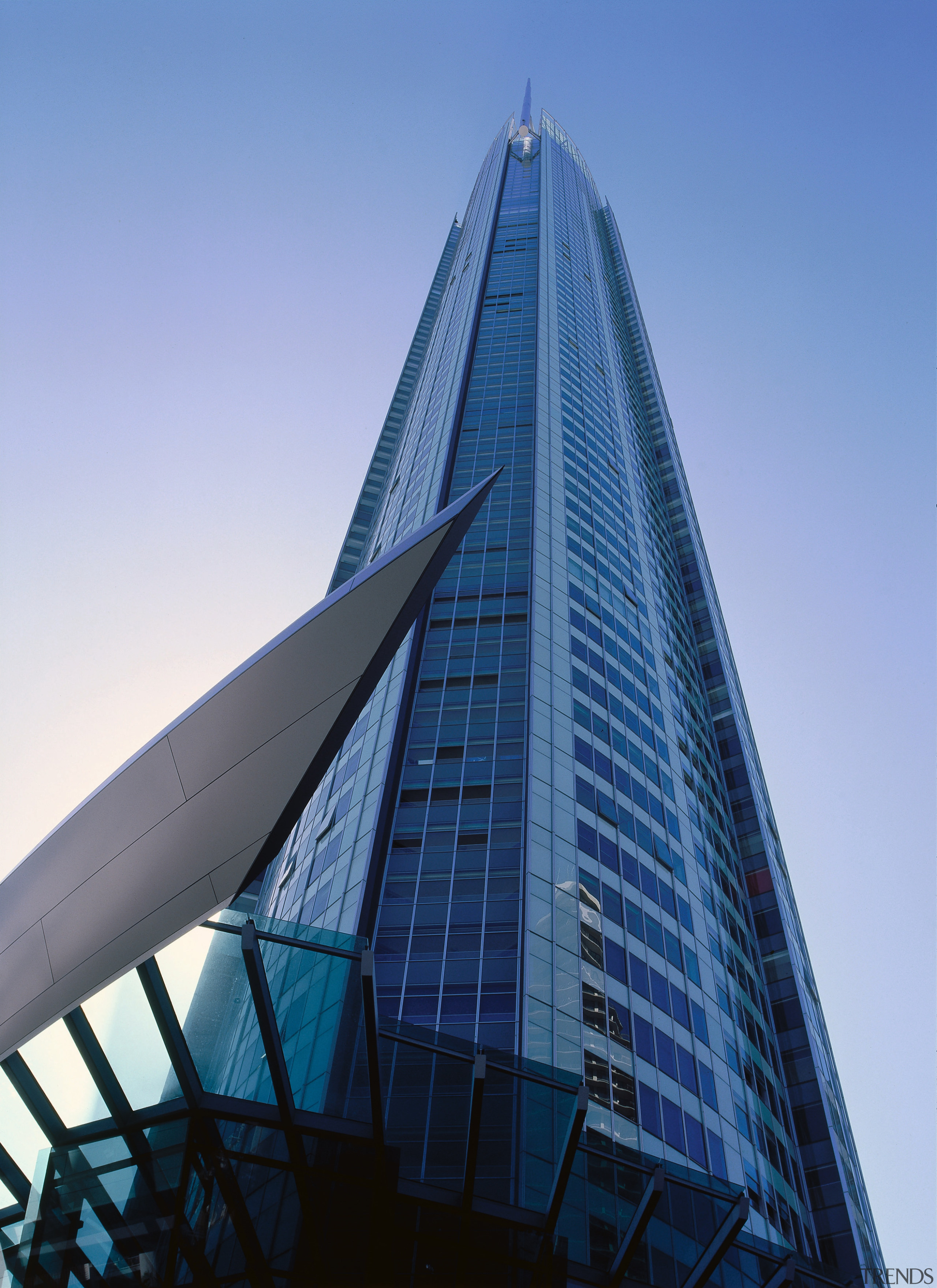 View of tall A1 apartment tower showing glass architecture, building, city, commercial building, condominium, corporate headquarters, daytime, headquarters, landmark, metropolis, metropolitan area, sky, skyscraper, tower, tower block, urban area, teal, blue