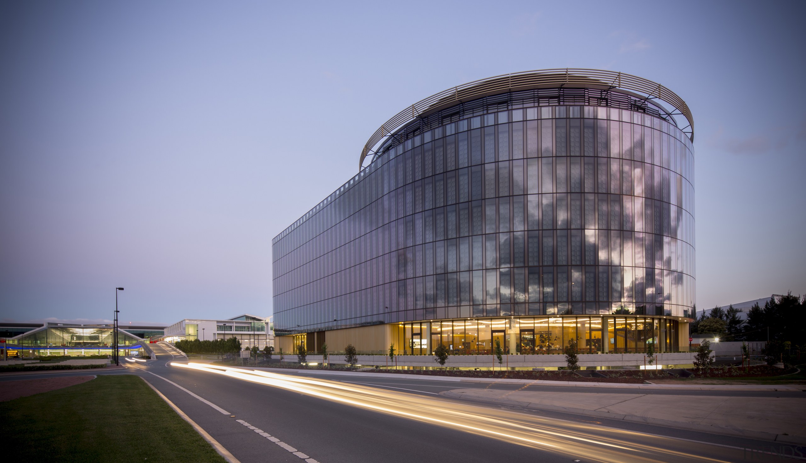 The Canberra Airport Hotel is a giant landmark architecture, building, commercial building, corporate headquarters, daytime, facade, headquarters, metropolis, metropolitan area, mixed use, sky, urban area, teal