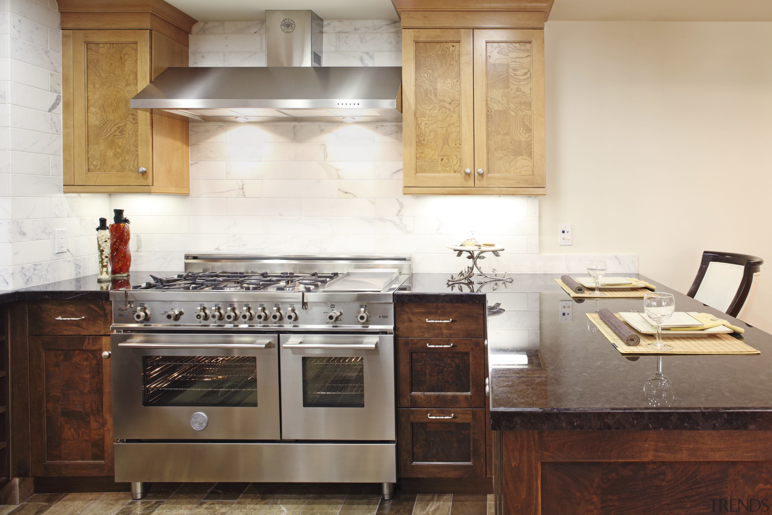 View of a contemporary kitchen which features a cabinetry, countertop, cuisine classique, furniture, hardwood, home appliance, interior design, kitchen, kitchen appliance, kitchen stove, room, white