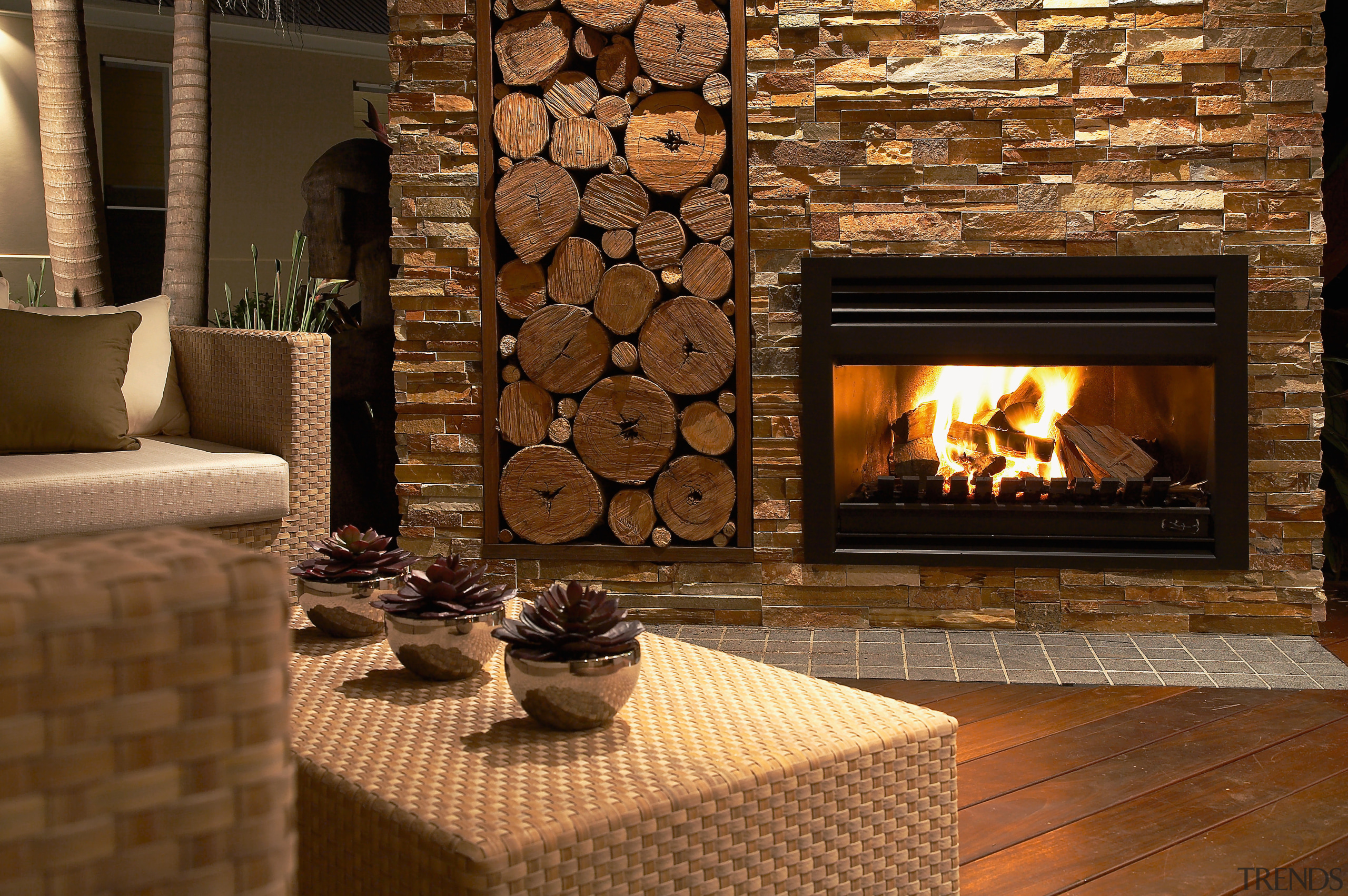 A close up view of the stone all fireplace, flooring, hearth, heat, home, interior design, living room, wood burning stove, brown