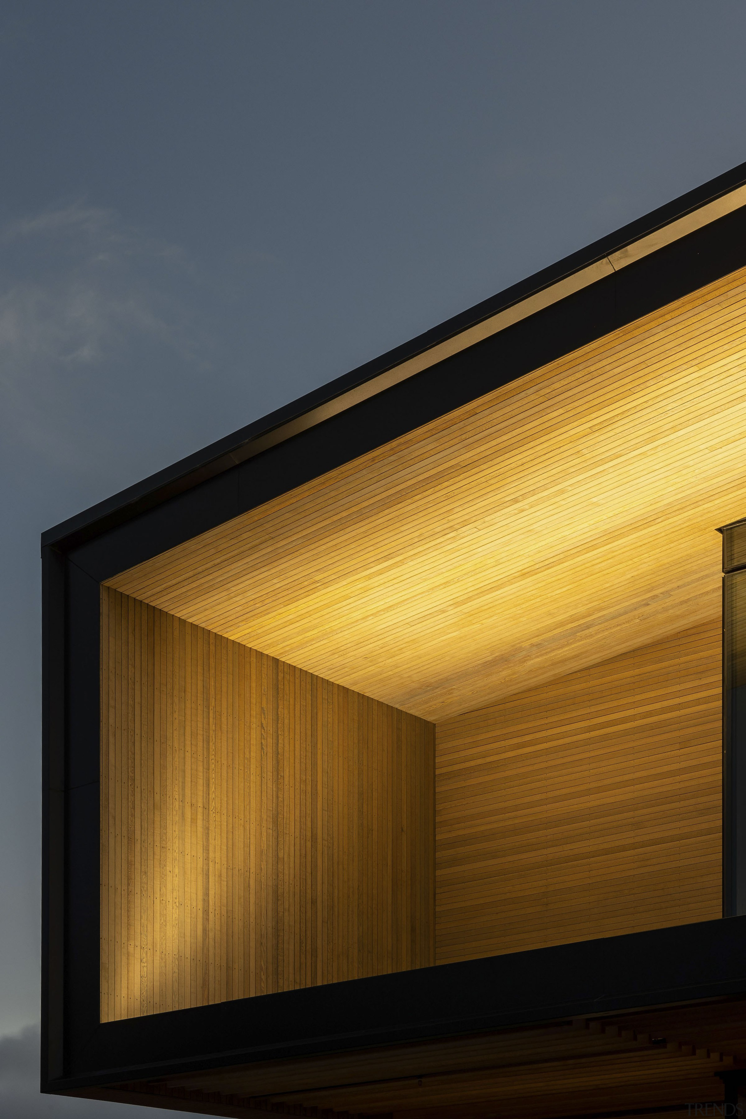 Internal lighting highlights the timber joinery. 