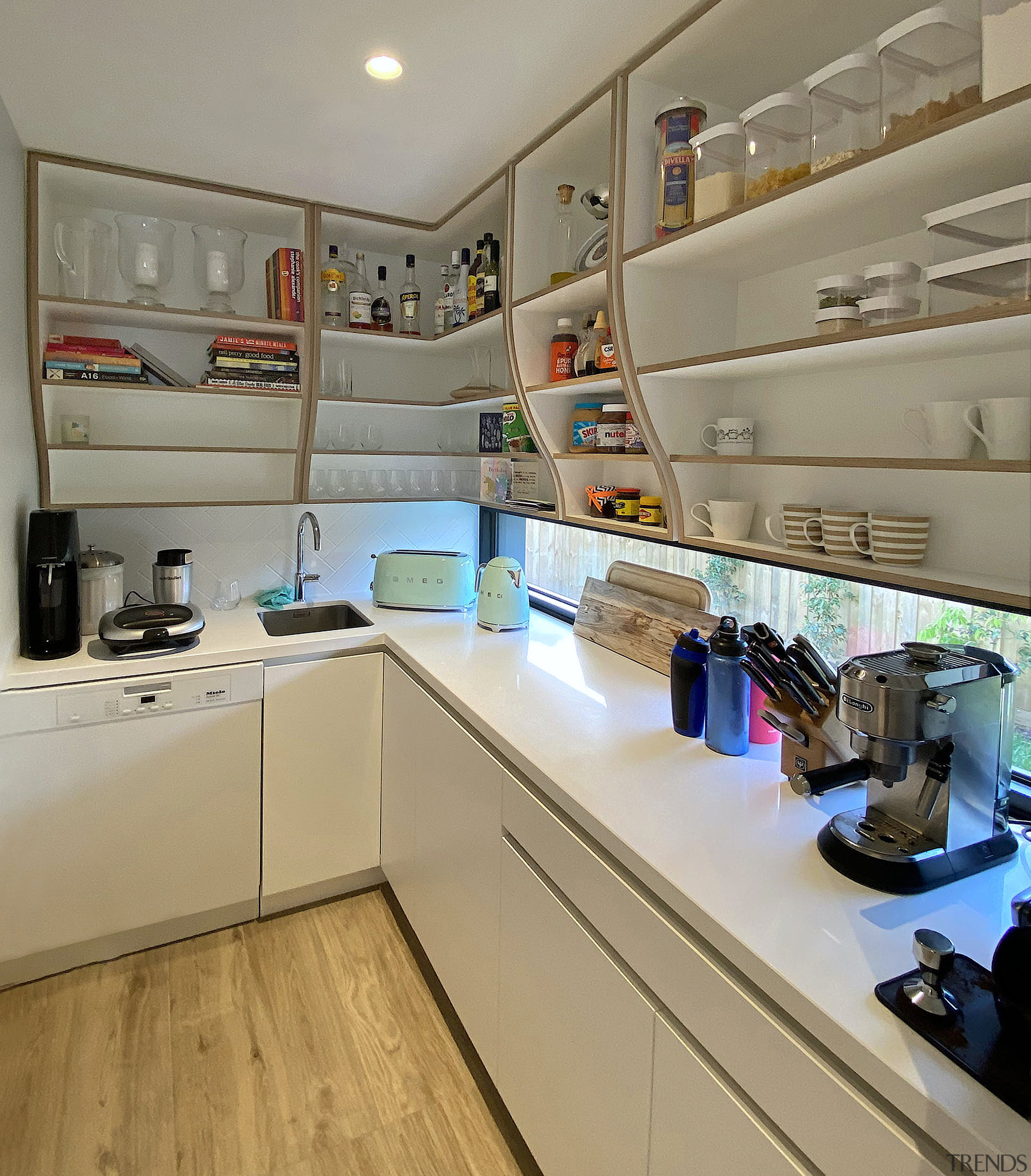 Scullery complete with curvaceous upper display cabinetry. 