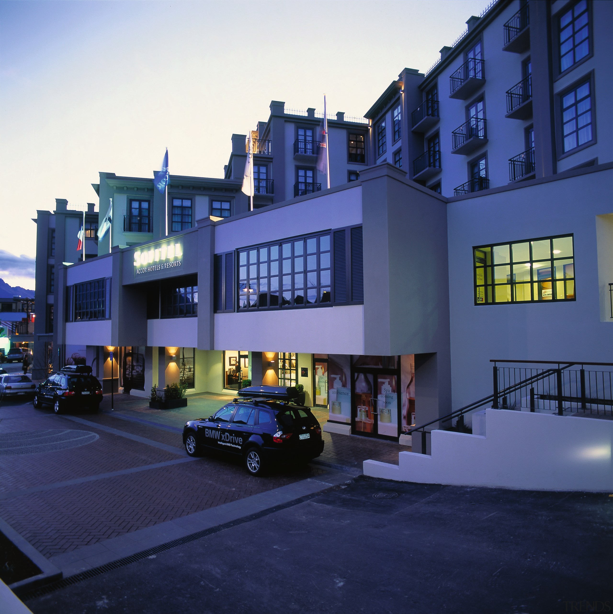 An exterior view of the Soffitel hotel in apartment, architecture, building, car, commercial building, condominium, facade, family car, home, house, luxury vehicle, metropolitan area, mixed use, neighbourhood, property, real estate, residential area, sky, window, blue