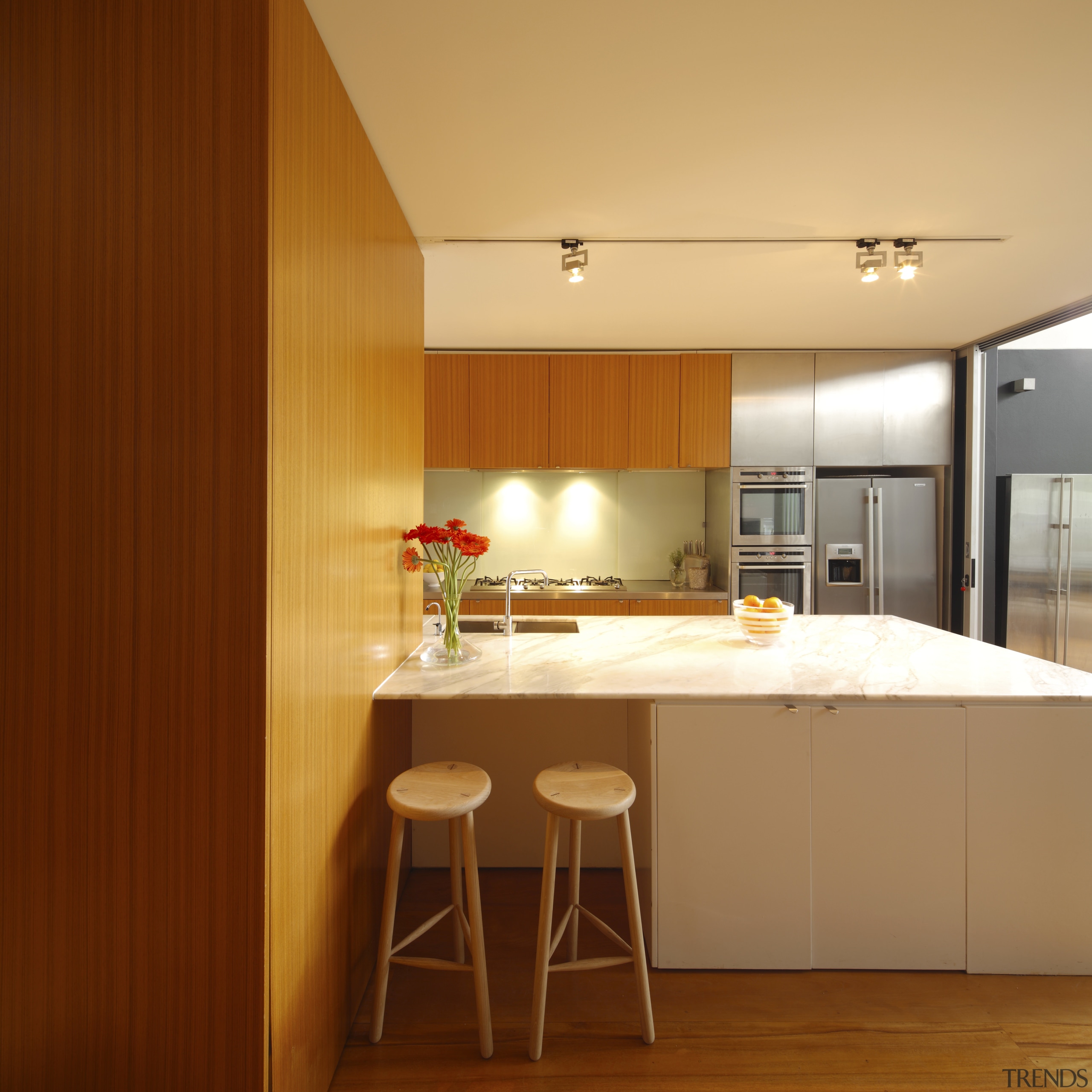 Kitchen with wooden cupboards, white island stainless fridge. architecture, cabinetry, ceiling, countertop, interior design, kitchen, room, table, brown, orange