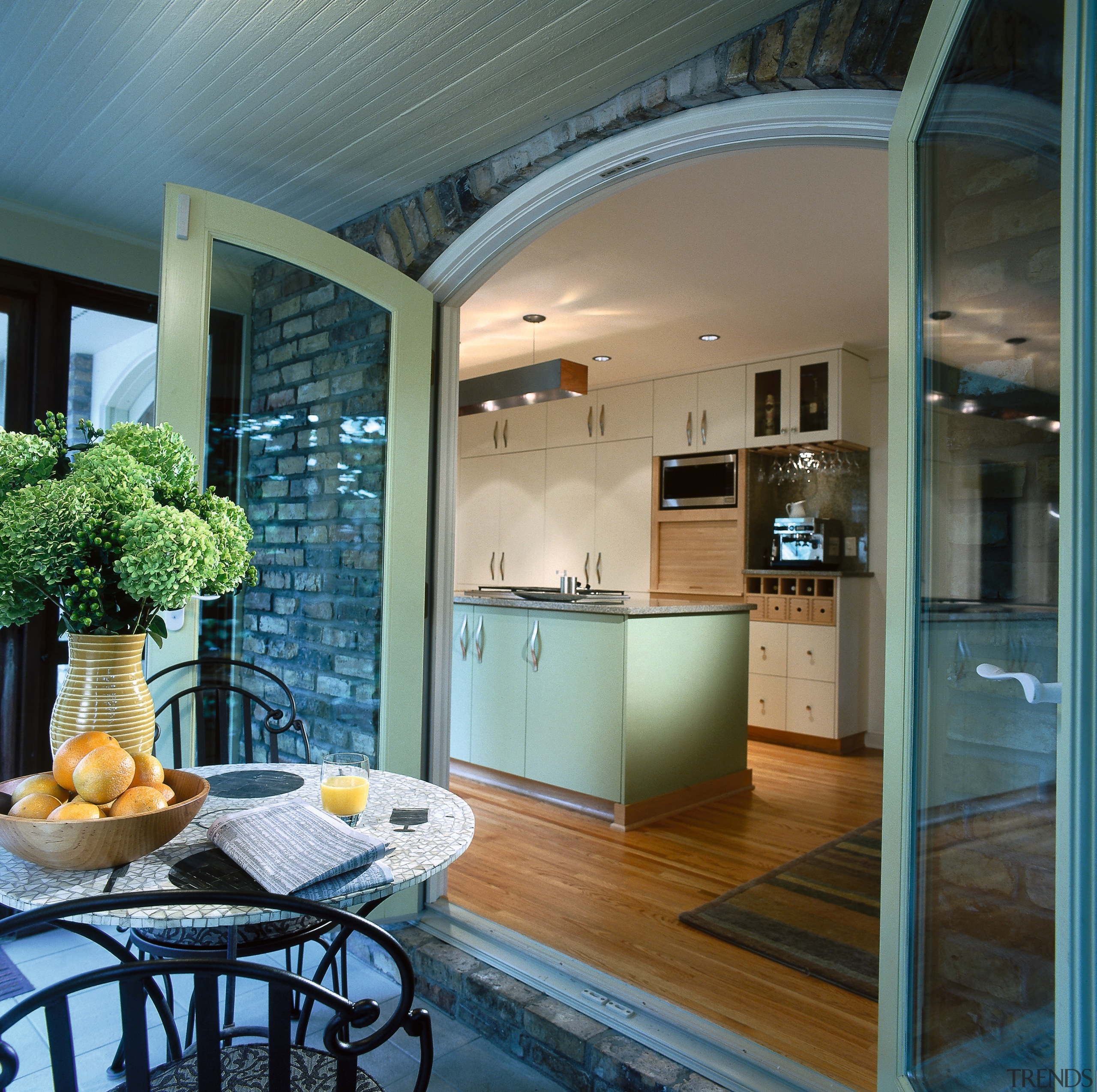 Kitchen leading out onto a covered patio. Outside: ceiling, countertop, home, interior design, kitchen, real estate, window