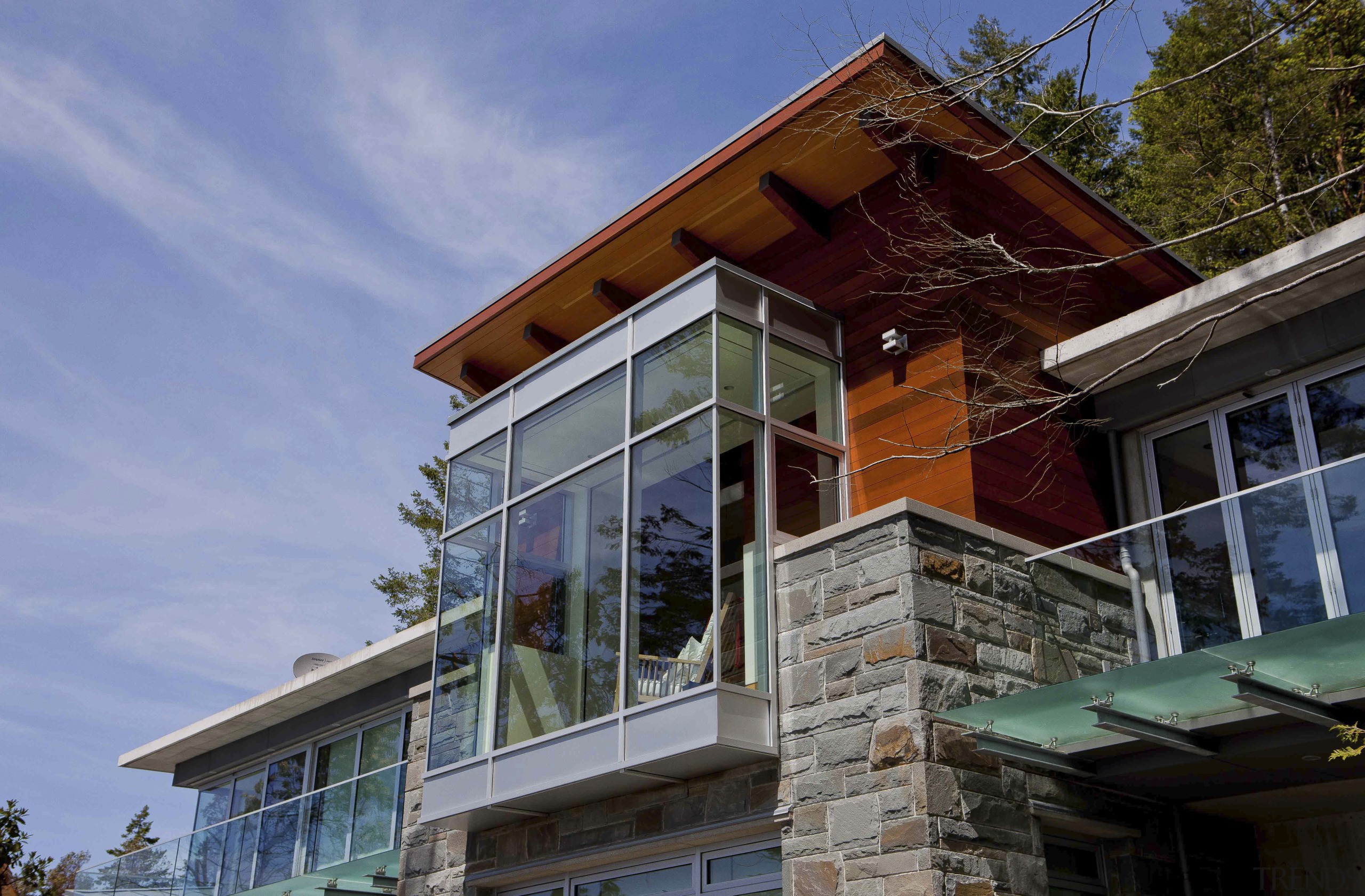 Exterior view of house with stone pillars. - architecture, balcony, building, cottage, facade, home, house, property, real estate, roof, siding, window, teal