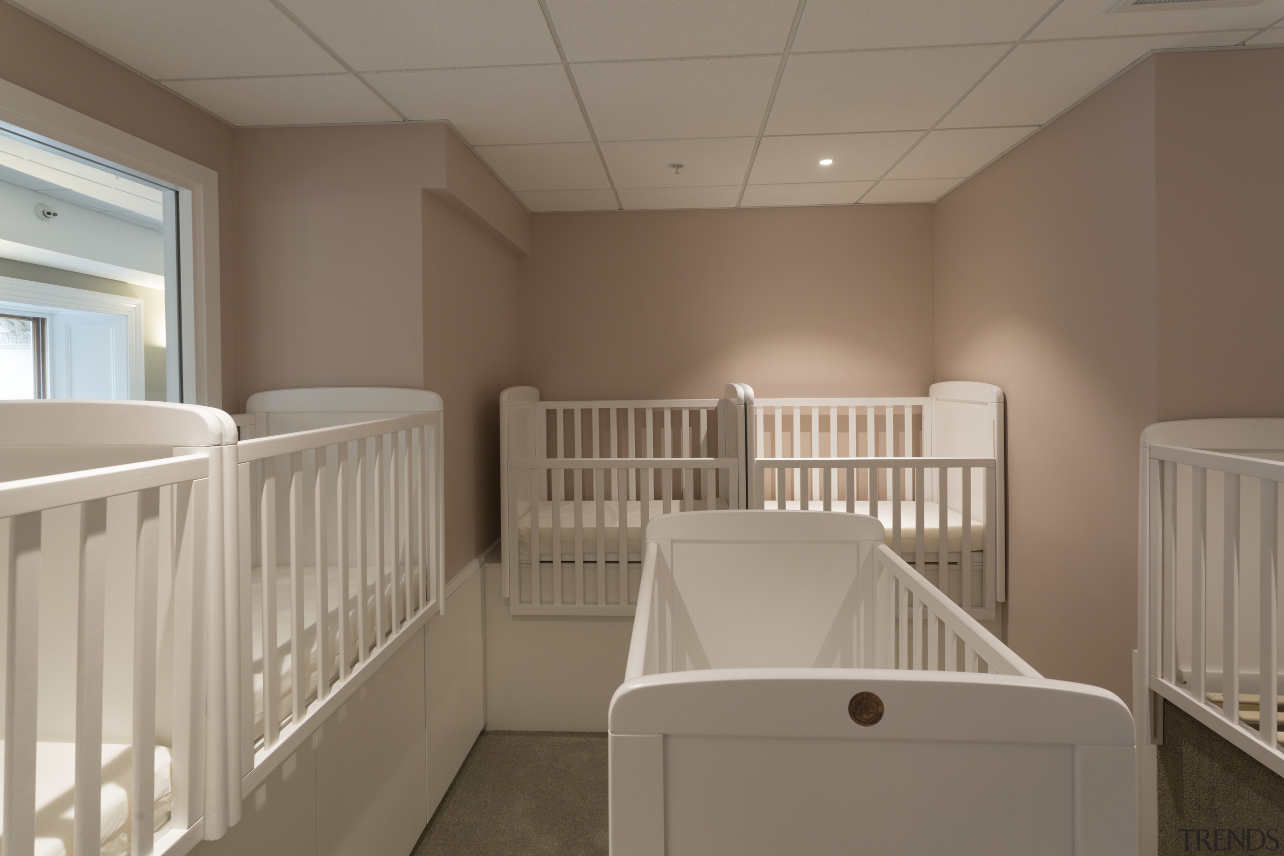 The sleeping room for infants enrolled at Cosmokids ceiling, floor, furniture, home, product, room, window, brown, gray