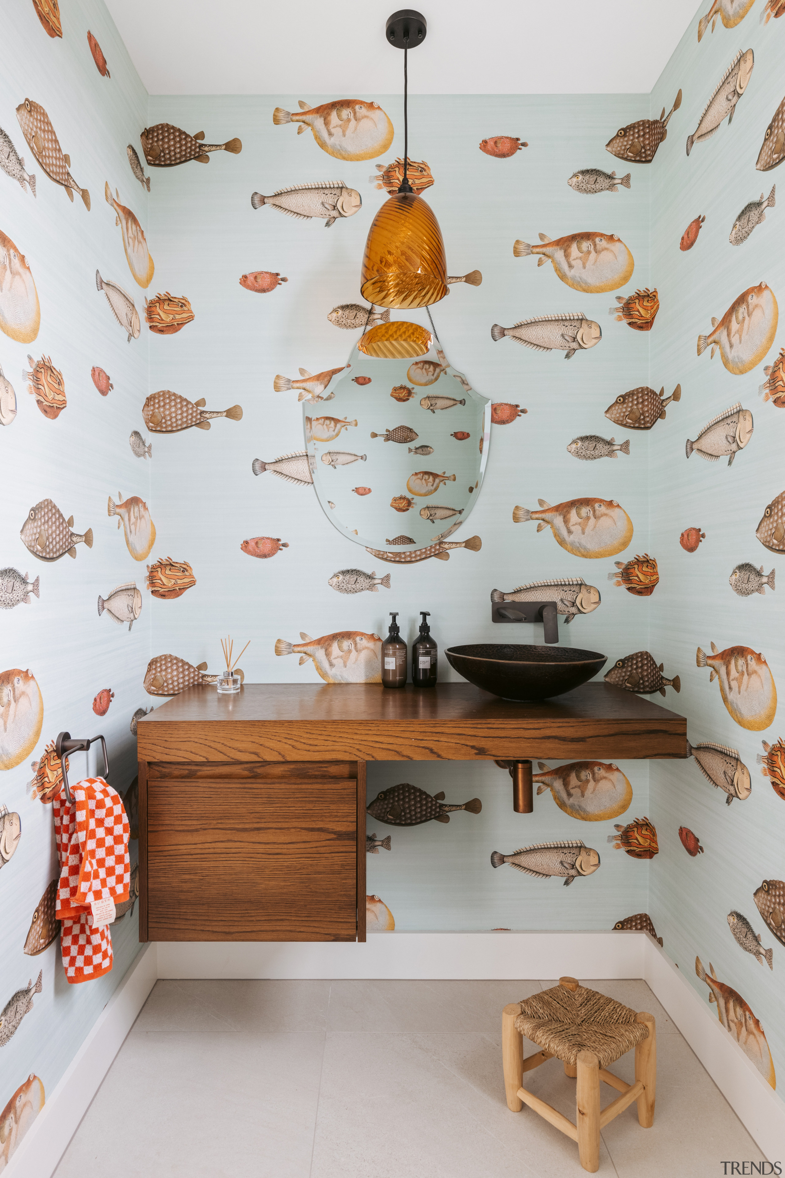 The powder room upstairs features fish wallpaper and 
