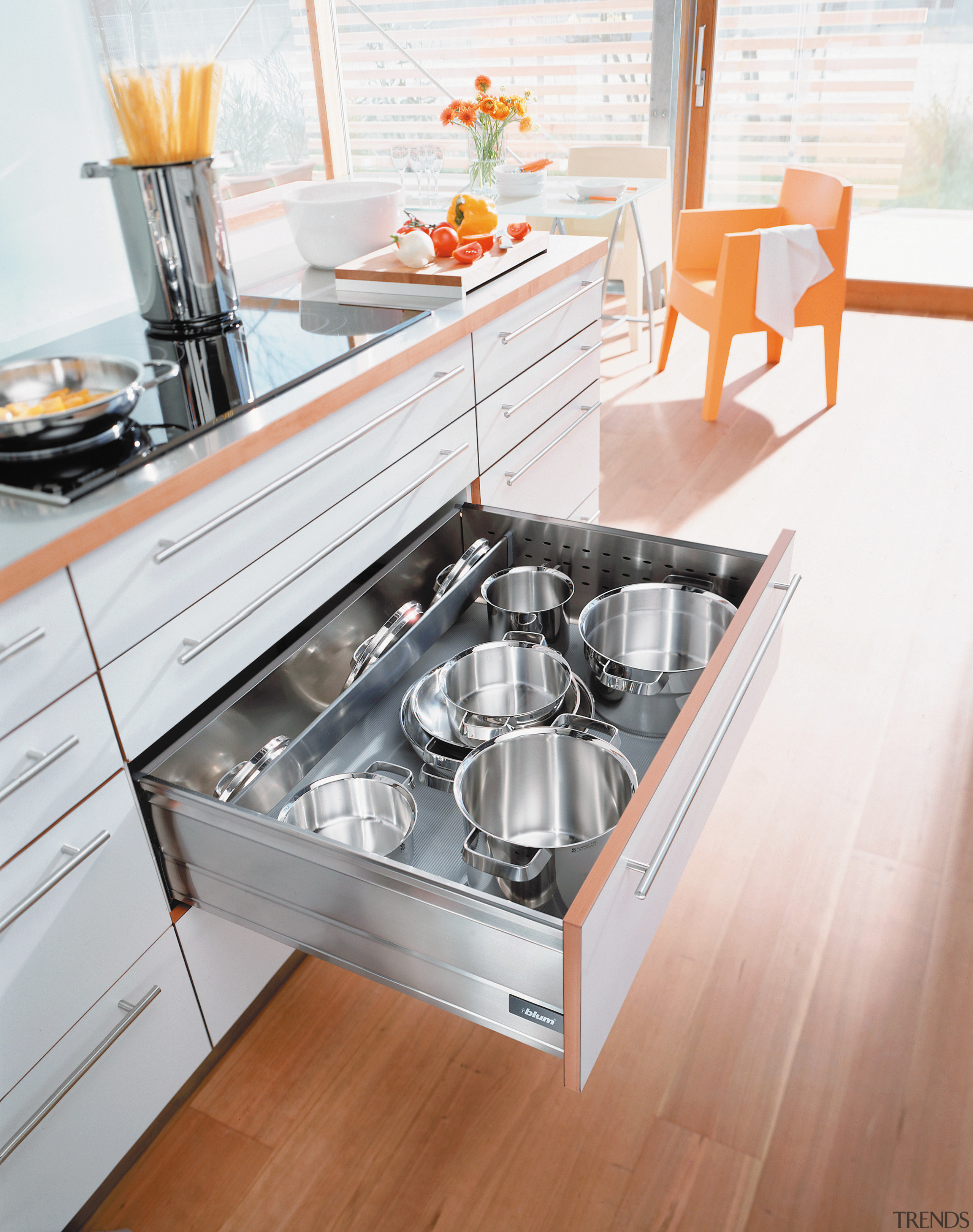 View of kitchen cabinetry and large pull out countertop, drawer, floor, furniture, kitchen, kitchen appliance, kitchen stove, product design, sink, table, white