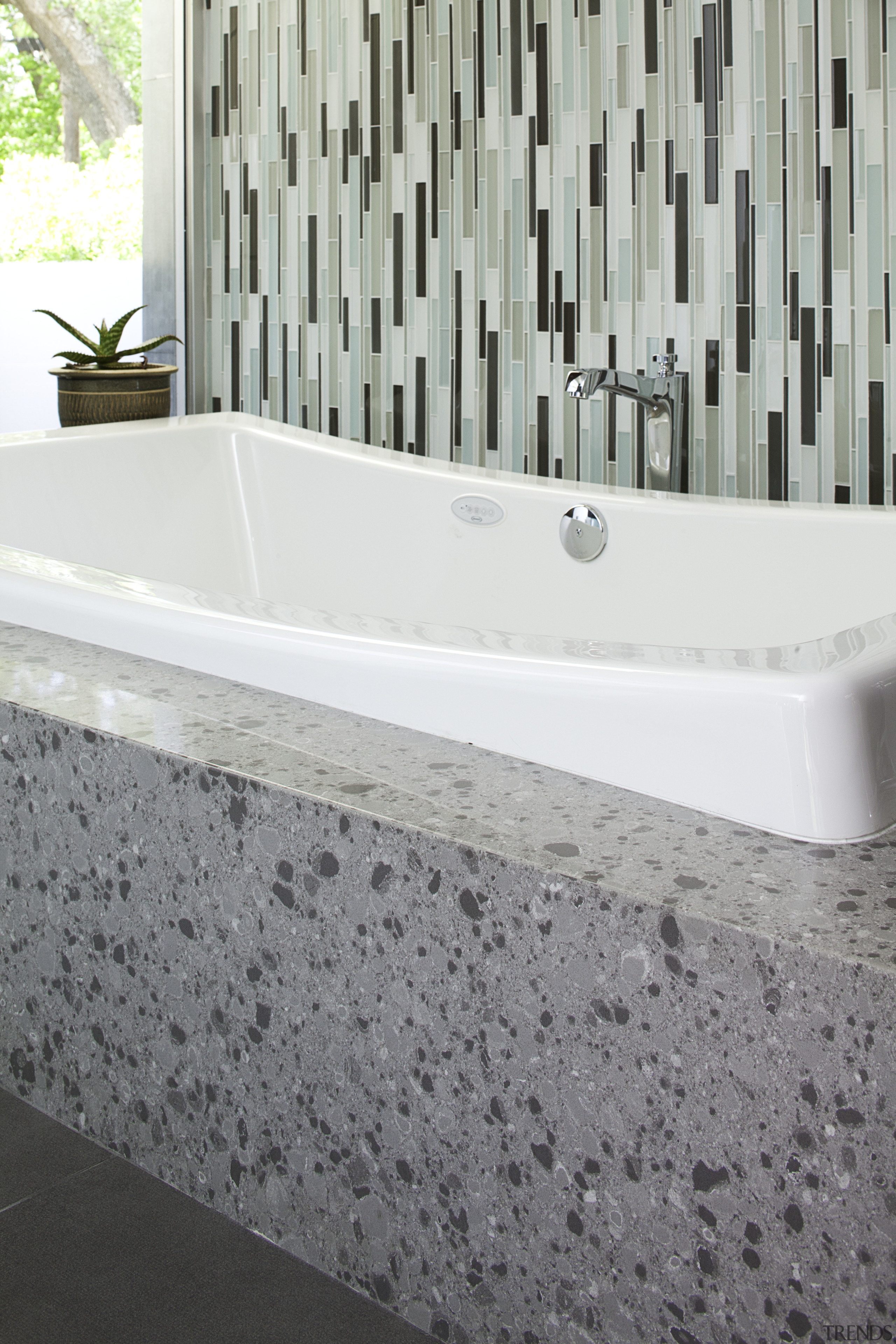 View of white tub with grey surround and bathroom, bathtub, floor, flooring, plumbing fixture, sink, tile, wall, white, gray