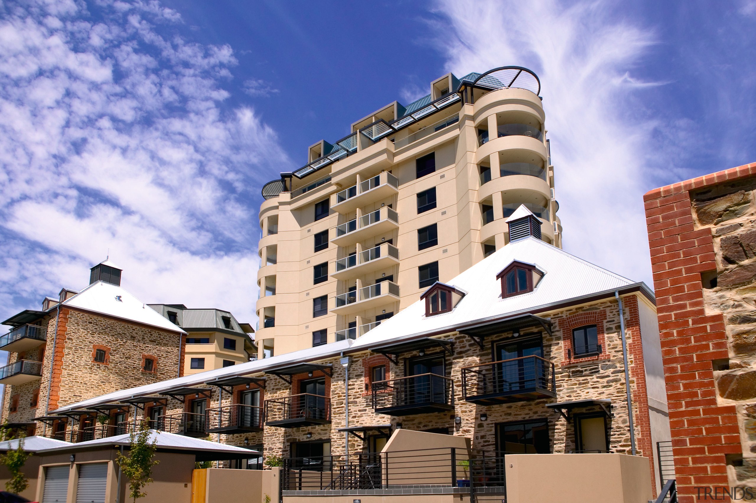 New high rise apartment building behind restored brewery apartment, architecture, building, city, condominium, estate, facade, home, house, mixed use, neighbourhood, property, real estate, residential area, roof, sky, town, urban area, window