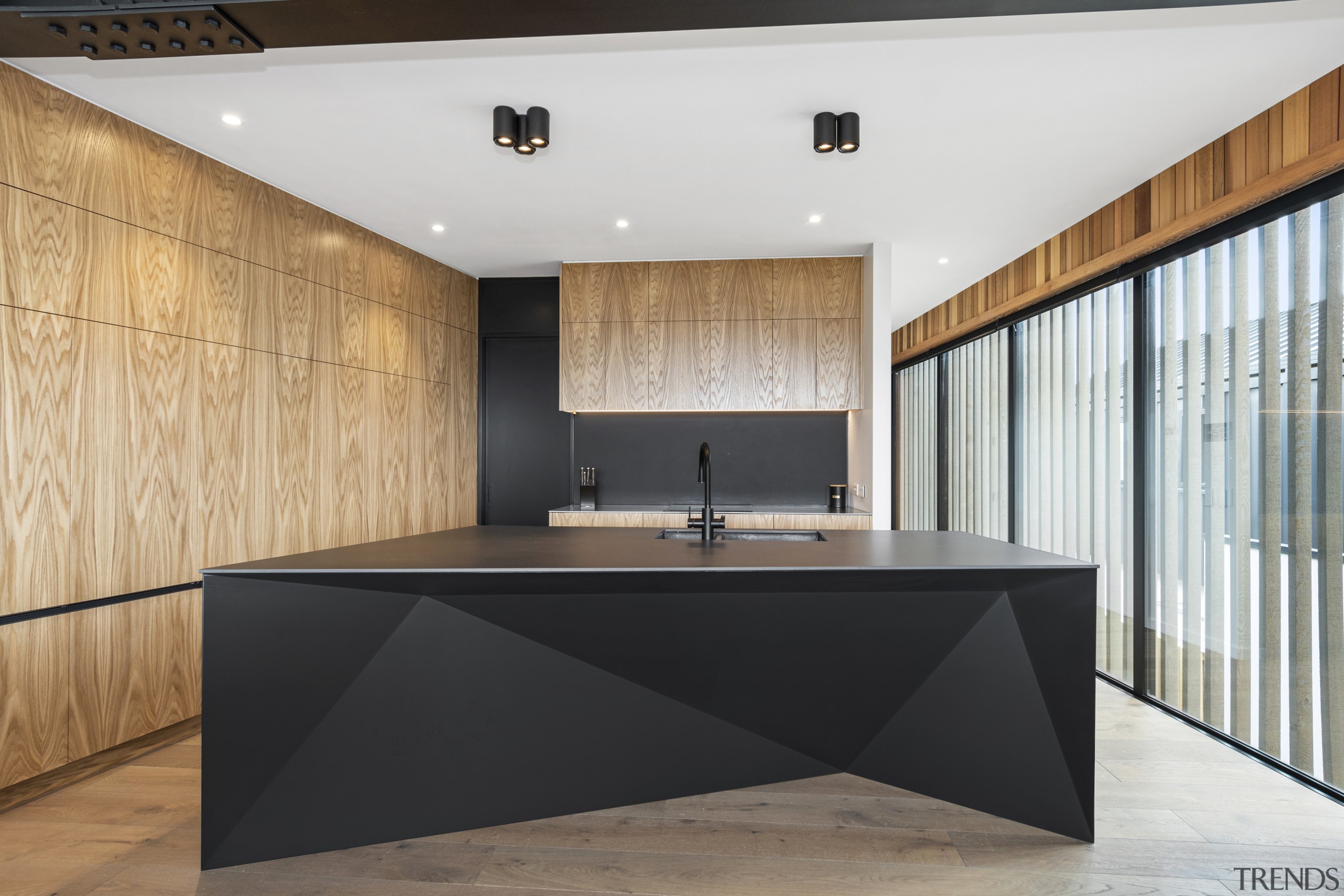 Matt black and faceted, the island would be 