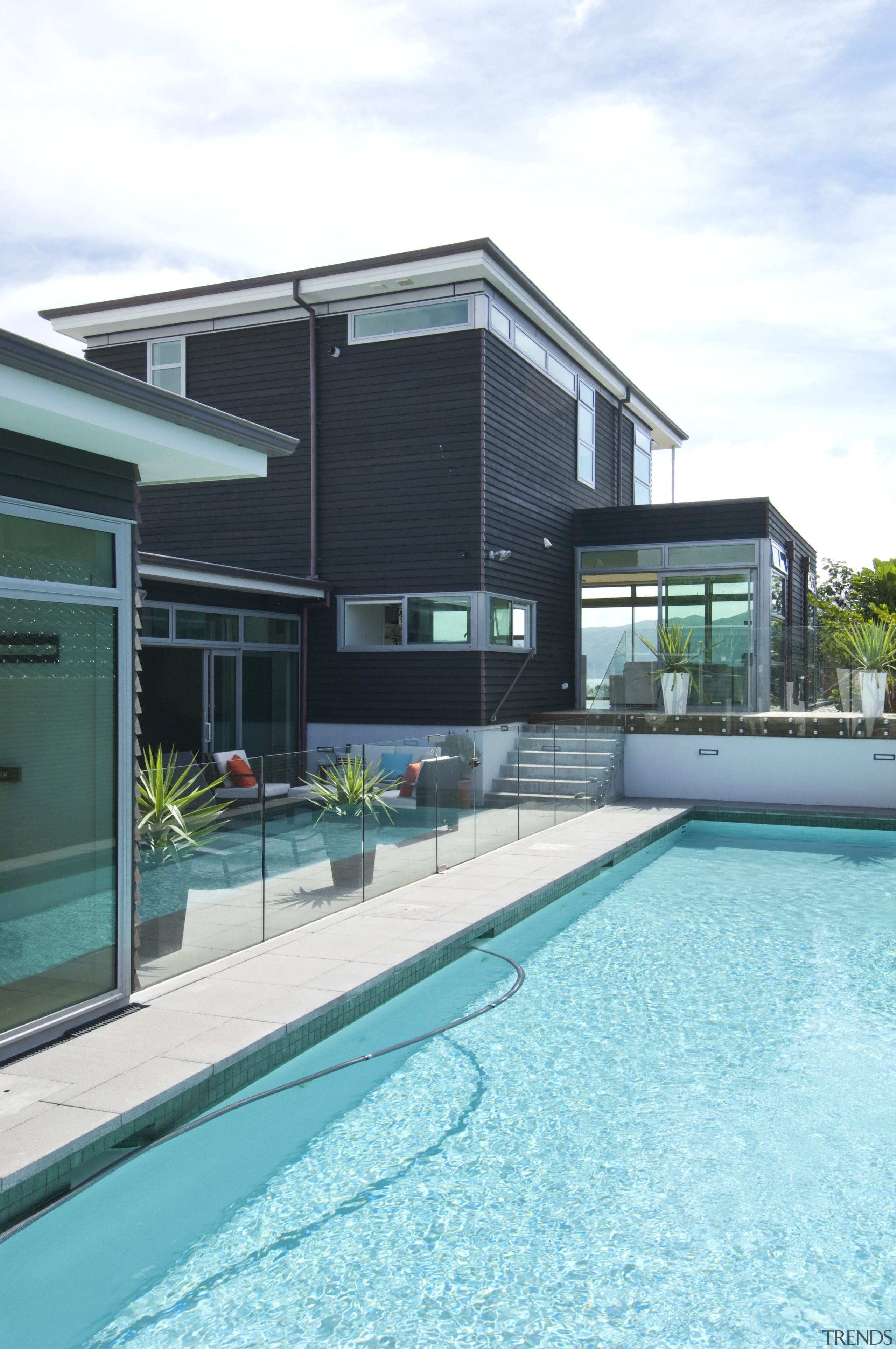 Poolside view of the contemporary home. - Poolside architecture, estate, facade, home, house, leisure, leisure centre, property, real estate, swimming pool, water, teal, white