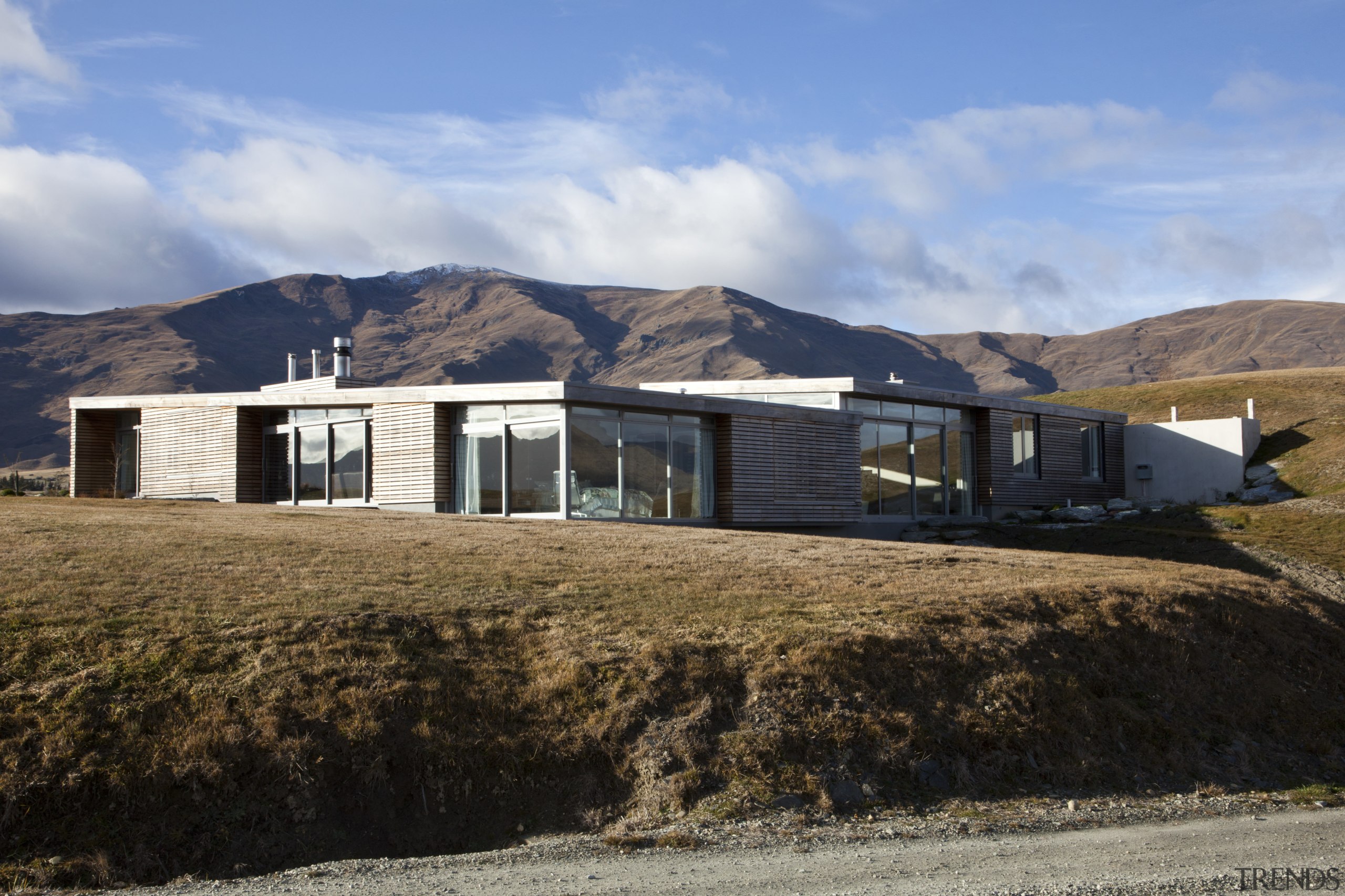 This home was designed by architect Nick Karlovsky. architecture, cottage, elevation, home, house, landscape, mountain, property, real estate, roof, sky, black
