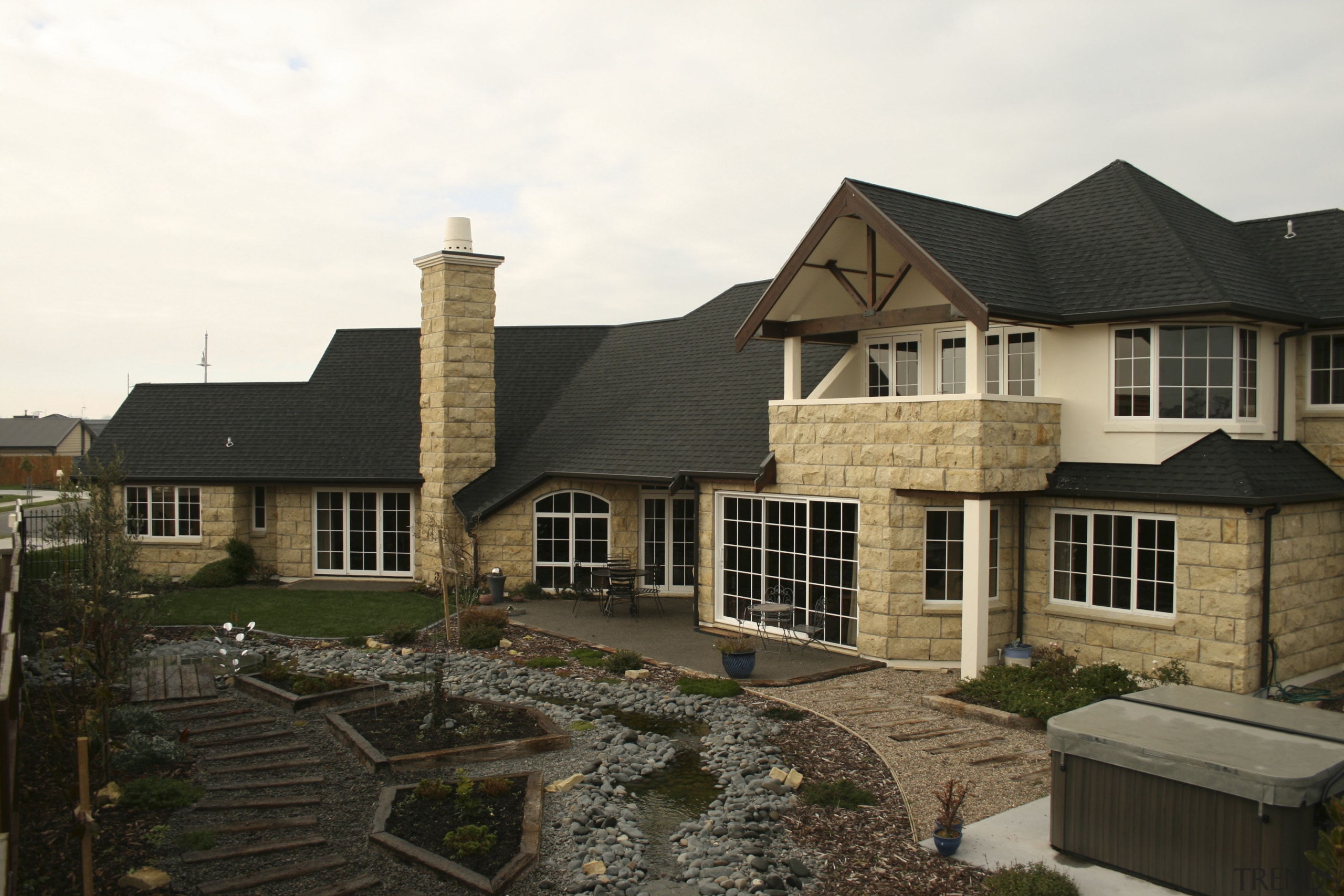 Exterior view of a home which features block cottage, elevation, estate, home, house, outdoor structure, property, real estate, residential area, roof, siding, window, black, white