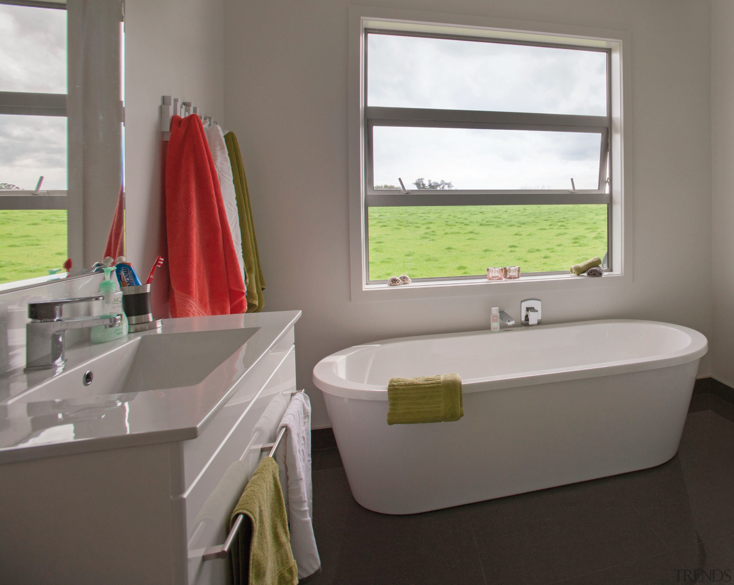 This master suite in a GJ Gardner Homes bathroom, bathroom accessory, interior design, plumbing fixture, room, sink, window, gray