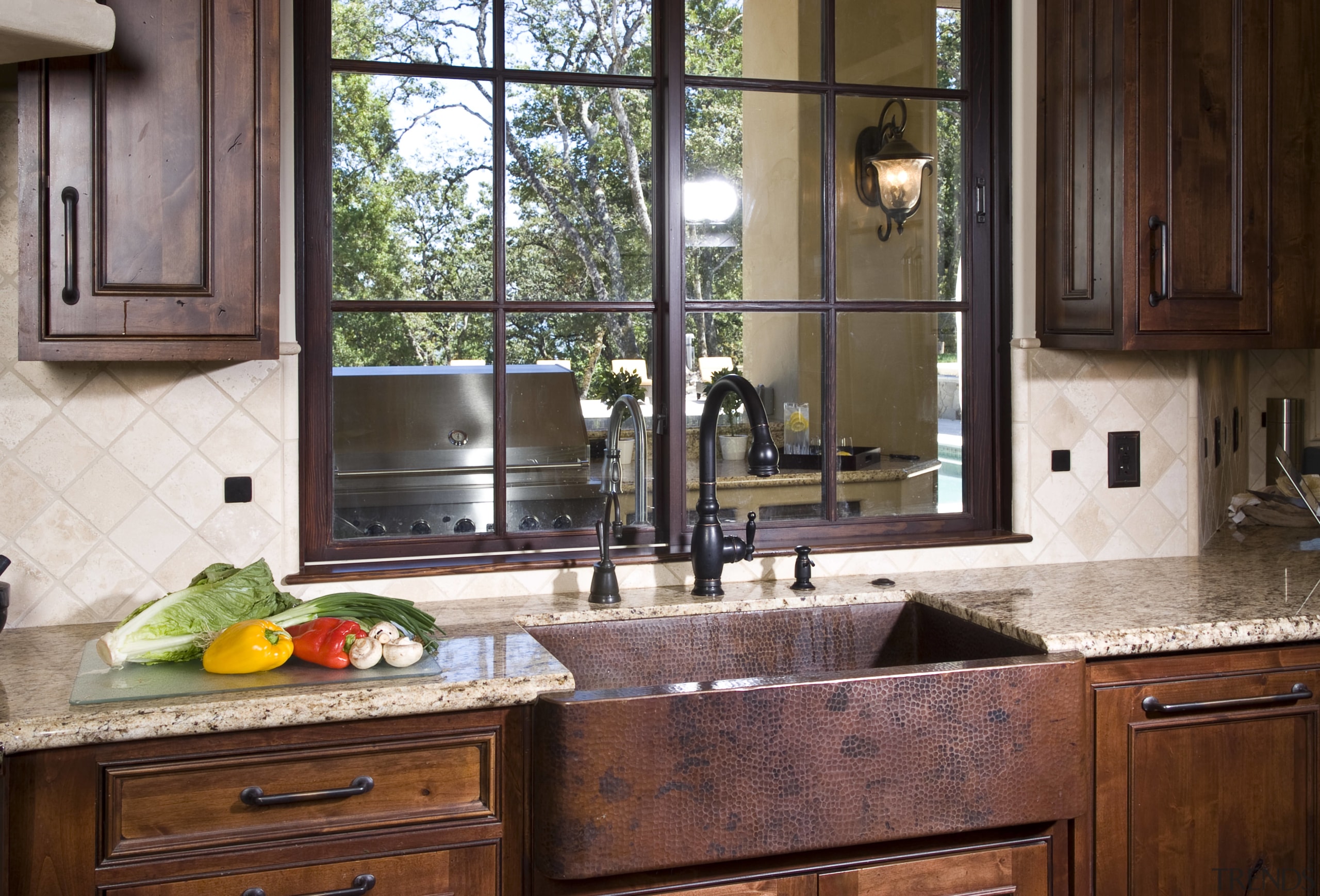 View of a Tuscan-styled kitchen which features dark-stained cabinetry, countertop, cuisine classique, home, interior design, kitchen, room, window, red