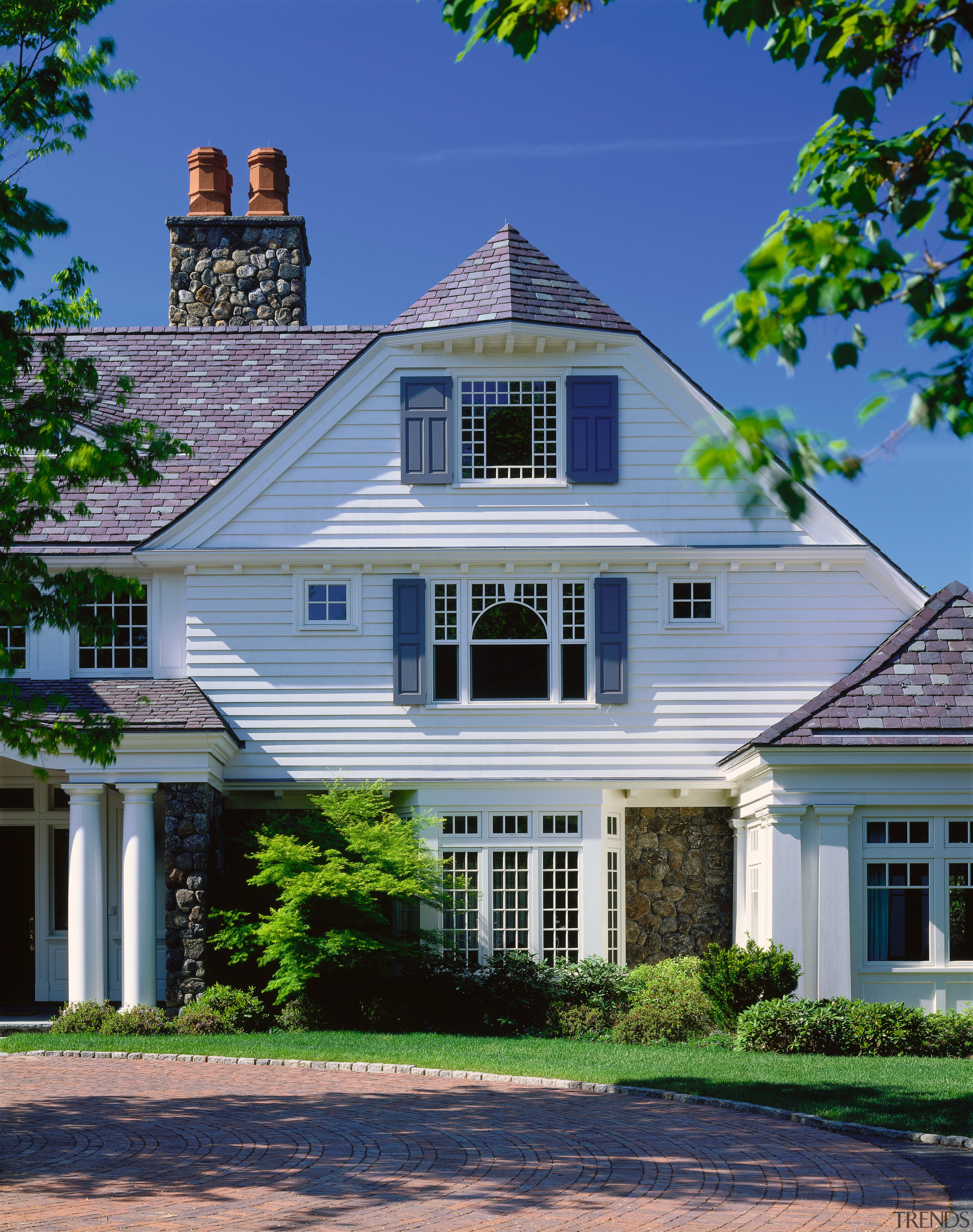 Exterior view of traditional style home with white architecture, building, cottage, elevation, estate, facade, farmhouse, historic house, home, house, landmark, mansion, neighbourhood, plantation, property, real estate, residential area, roof, siding, sky, suburb, window, blue