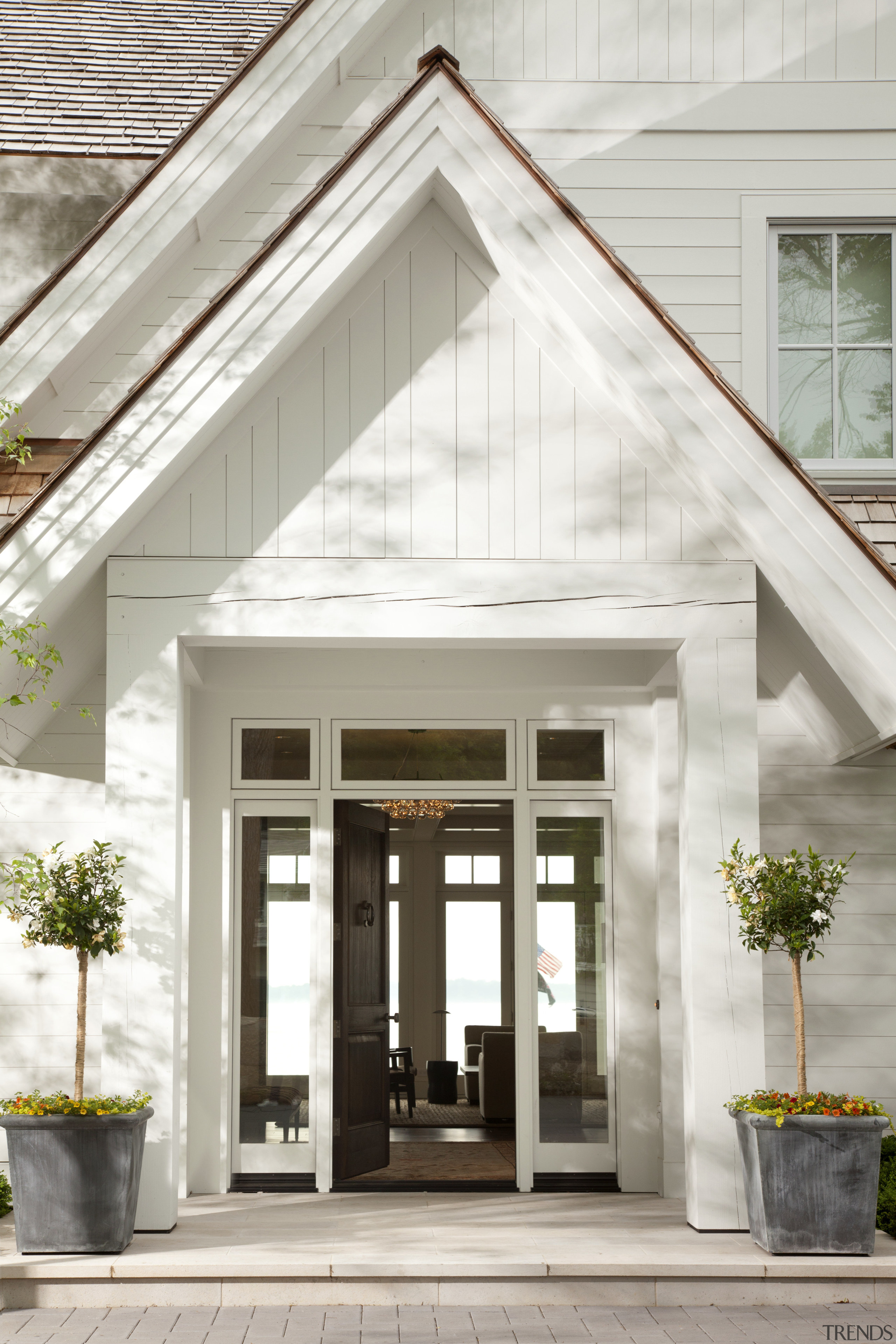Weathered beams and columns impart a sense of door, facade, home, house, white