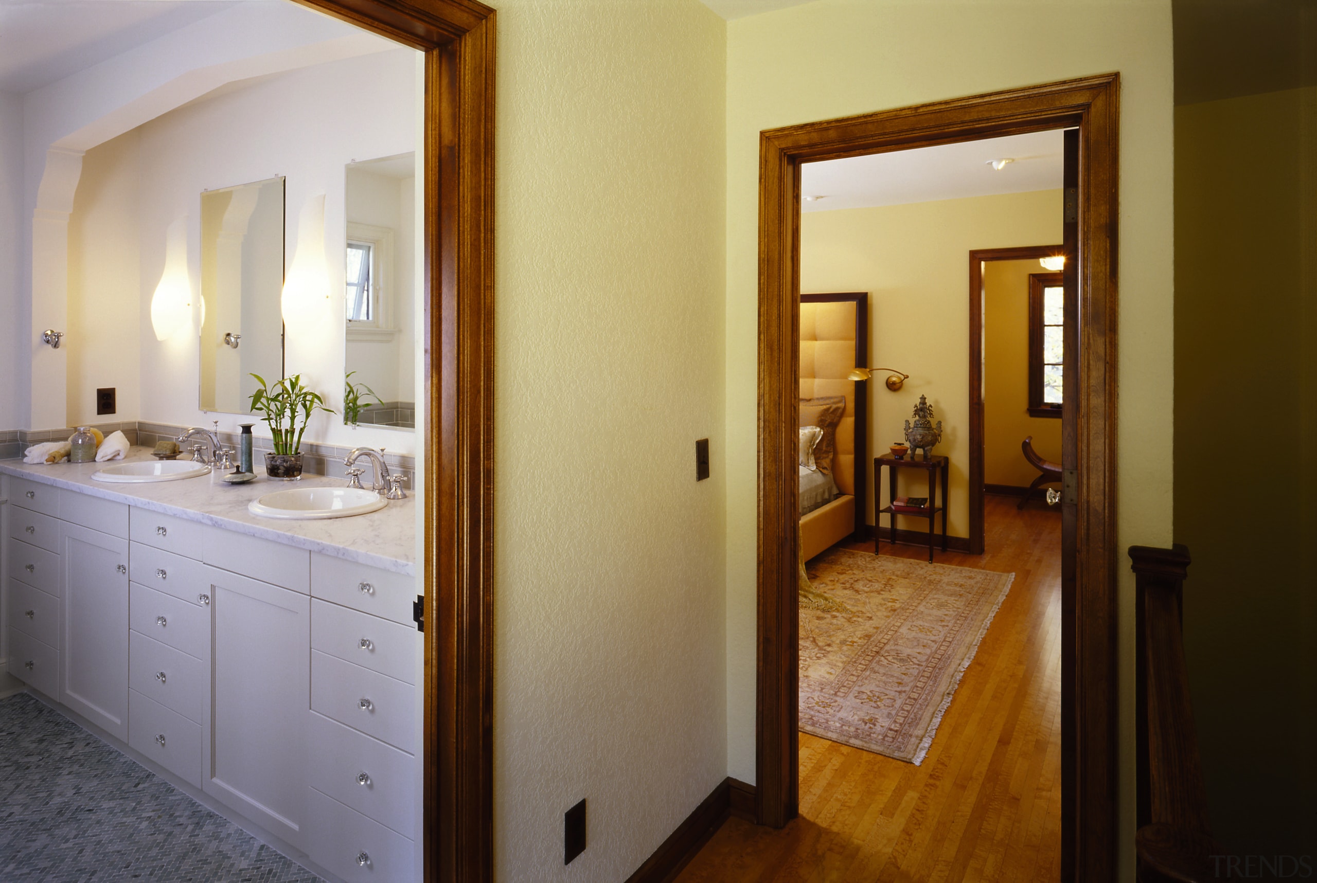 View of the doorways to the bathroom and bathroom, door, estate, floor, flooring, home, interior design, property, real estate, room, suite, wood, wood flooring, brown, gray