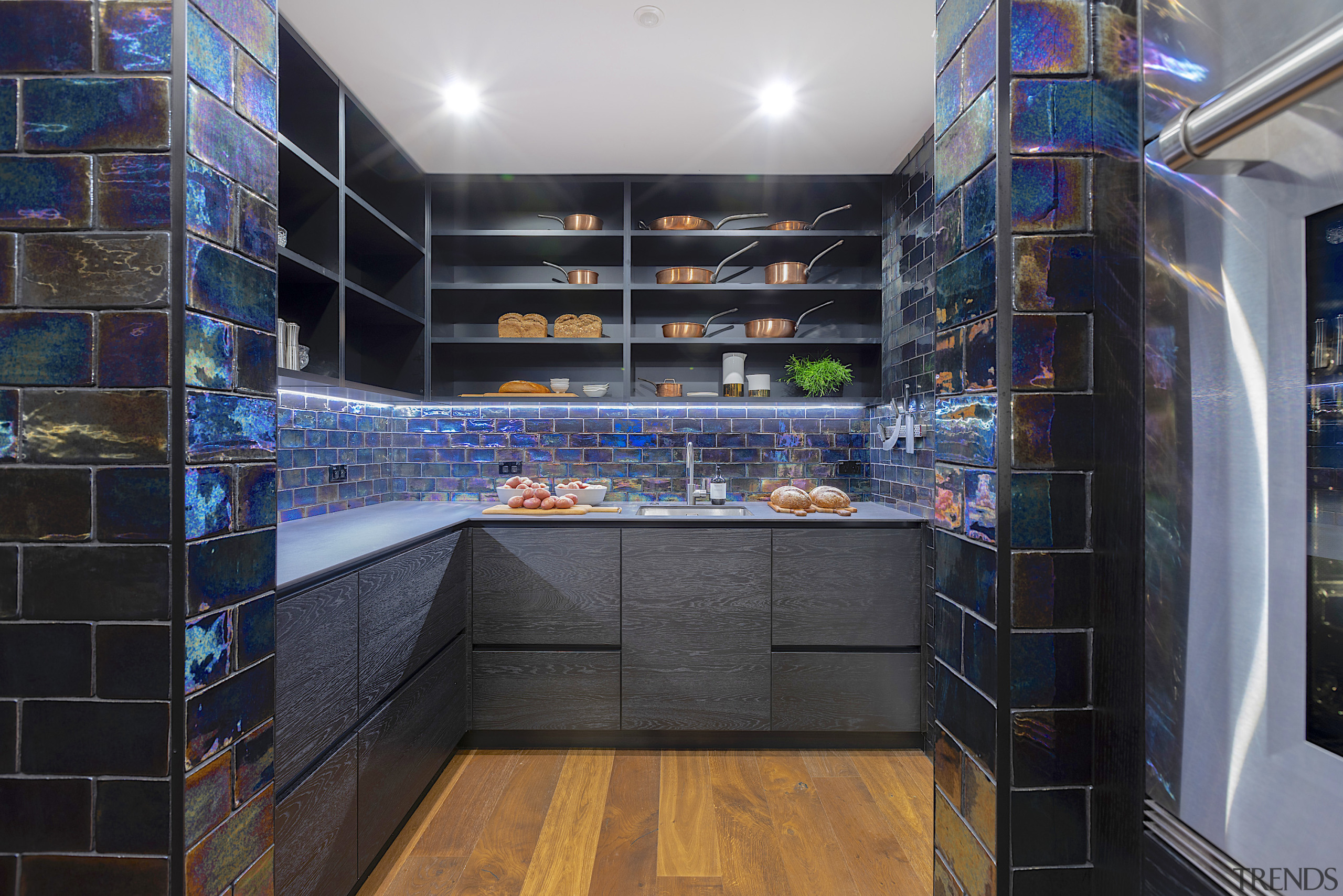 This kitchen was expanded by repurposing an adjacent black, gray