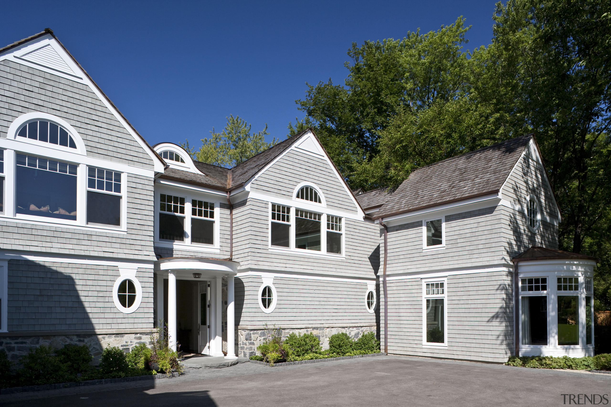 View of the homes exterior featuring stained cider building, cottage, elevation, estate, facade, farmhouse, historic house, home, house, mansion, neighbourhood, property, real estate, residential area, roof, siding, suburb, window, white