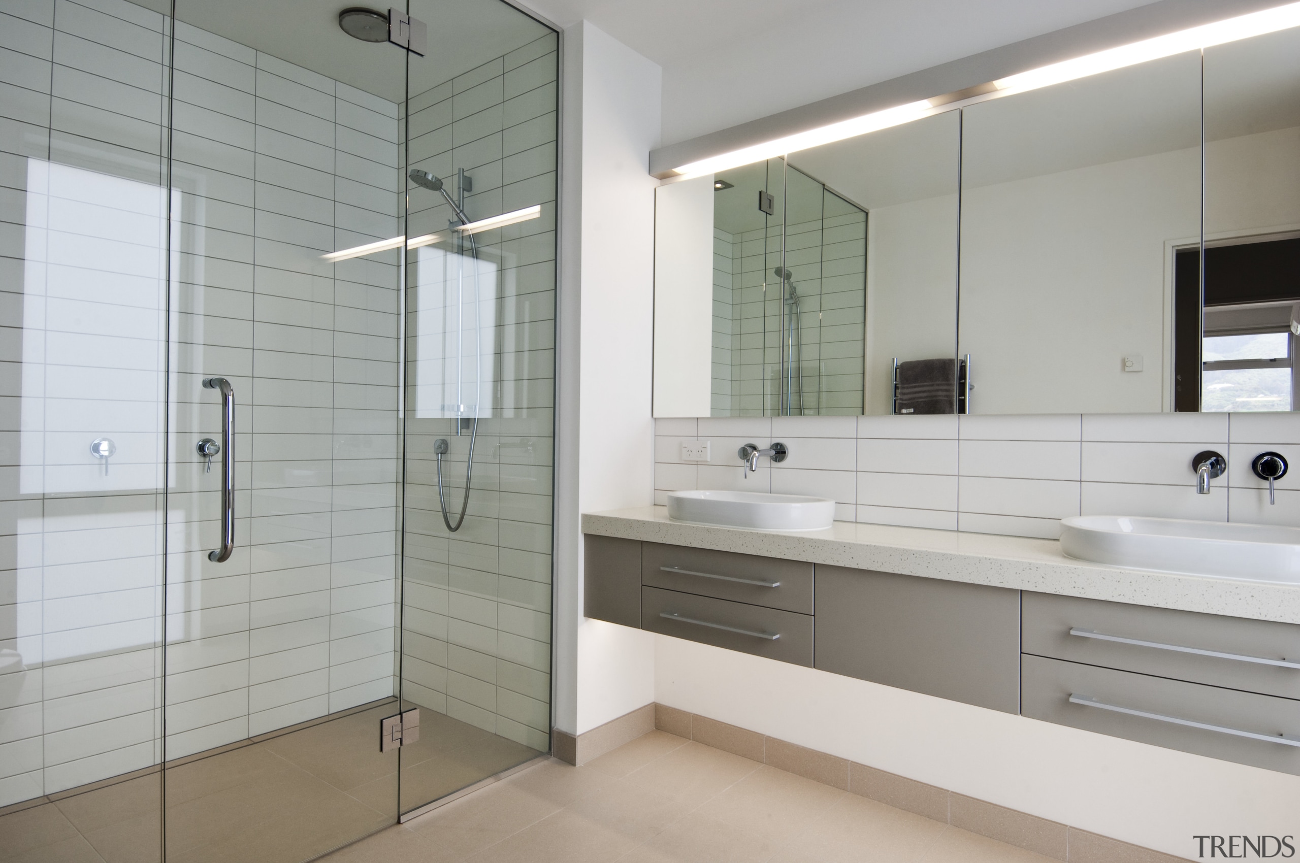 VIew of contemporary white and neutral-toned bathroom. bathroom, floor, interior design, room, sink, tile, gray