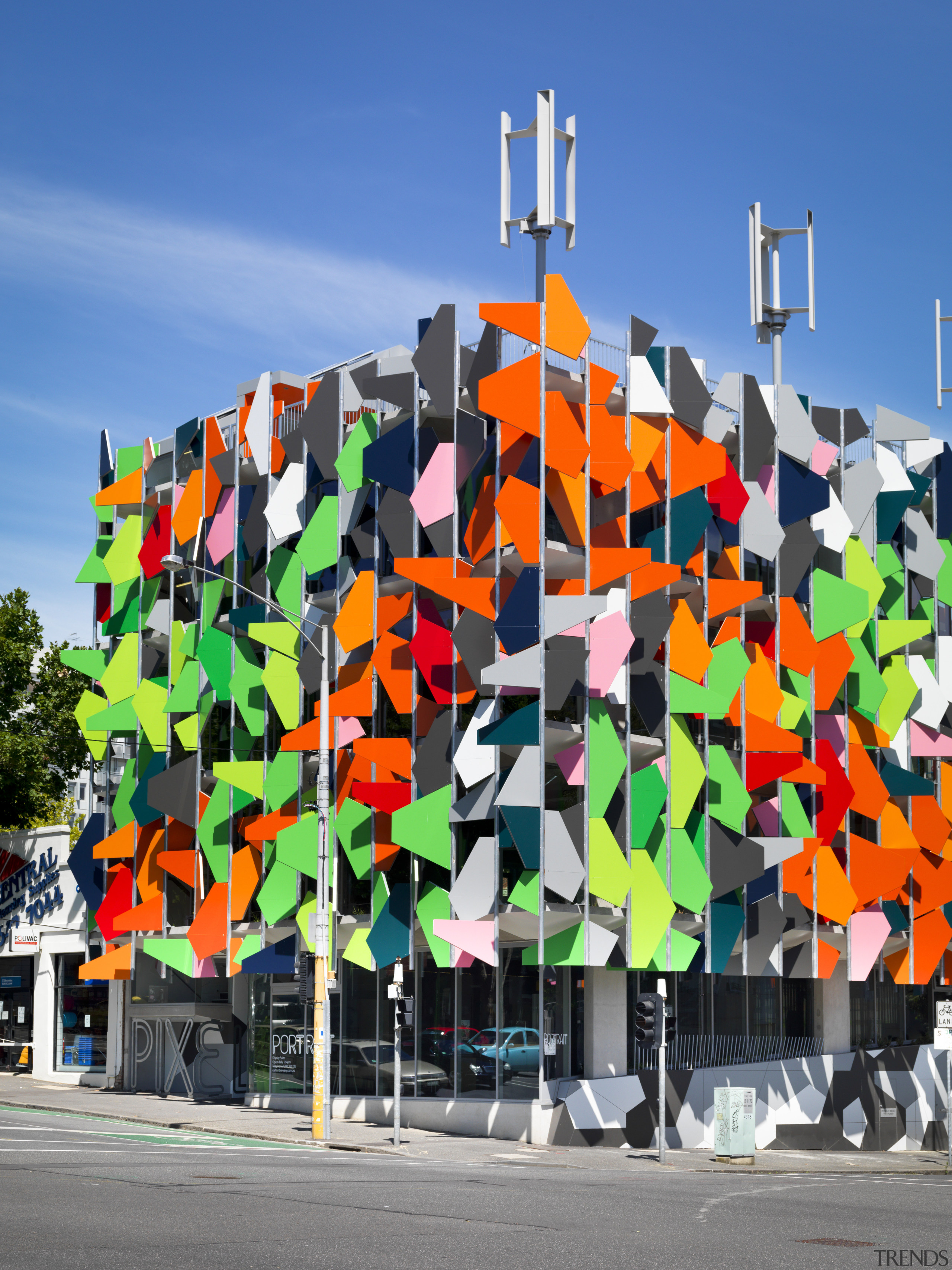 View of Pixel Building, with colorful exterior flags, art, graffiti