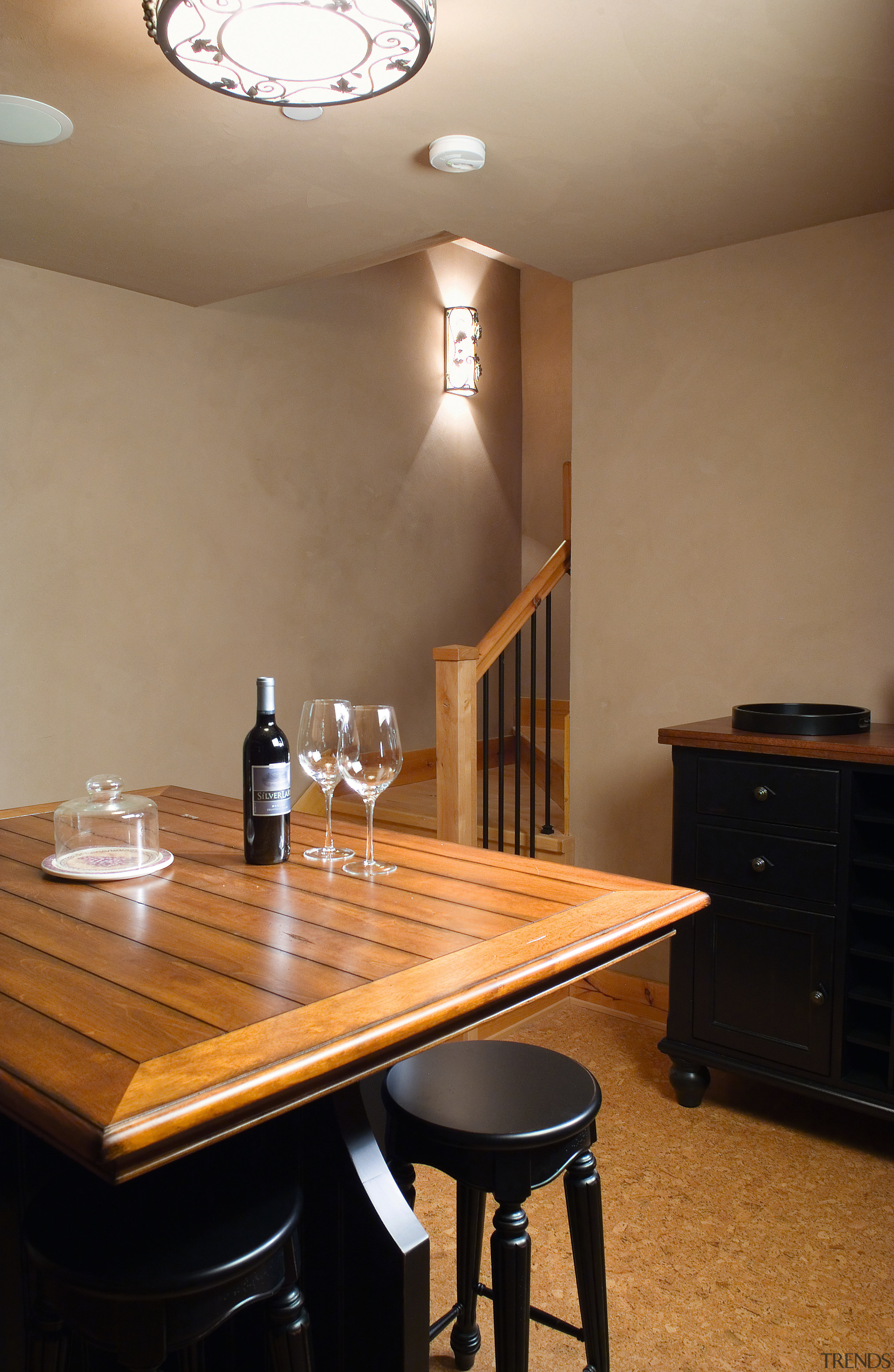 A view of these living areas in this ceiling, countertop, floor, flooring, furniture, home, interior design, light fixture, lighting, room, table, wall, wood, brown